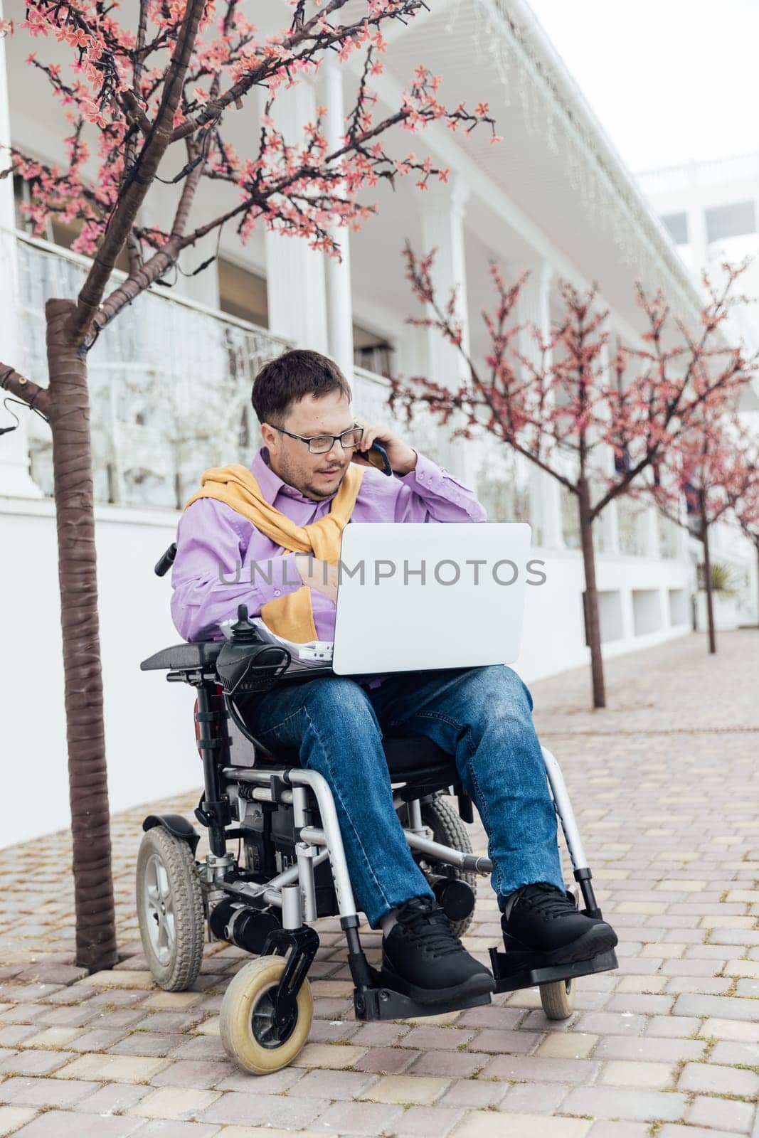 A person with with a laptop and a phone
