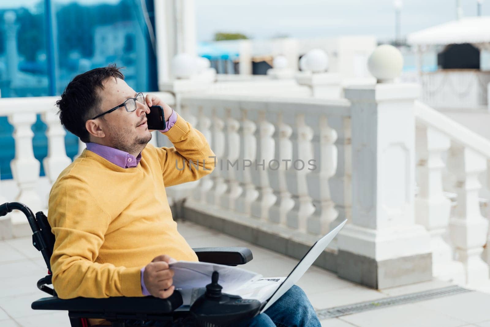 A person with a laptop and a phone