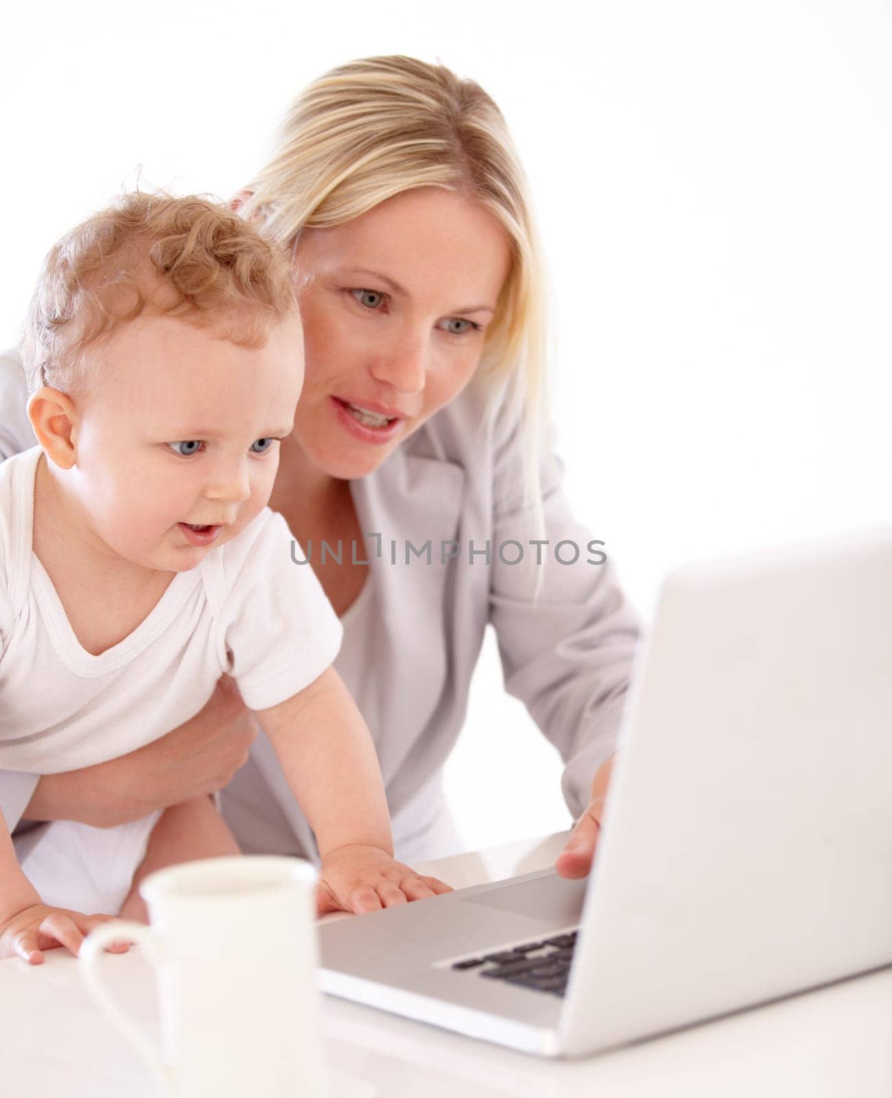 Businesswoman, baby and laptop for remote work in home for learning, playing or streaming on web. Mother, little boy and care for teaching, technology and skill for growth, development and milestone by YuriArcurs