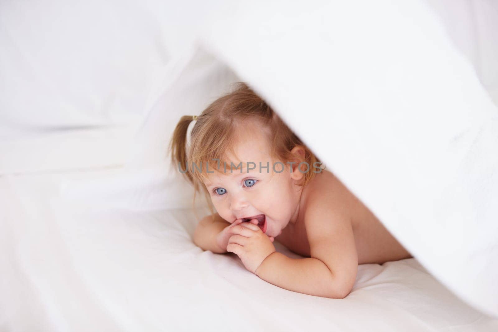 Home, growth and child development with a baby in the bedroom to relax alone in the morning. Happy, kids or youth and an adorable young infant girl on a bed with blankets for comfort in an apartment.