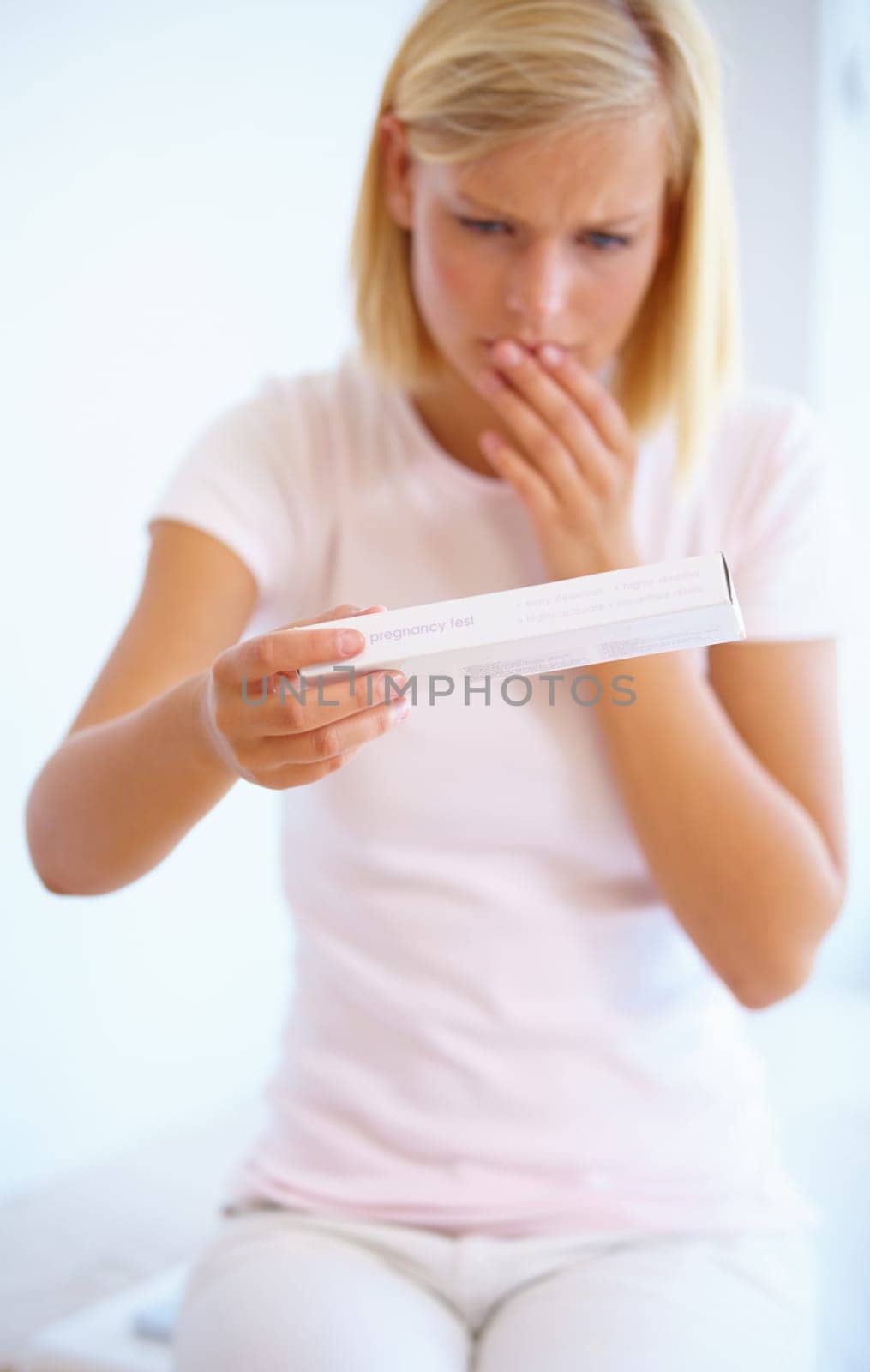 Anxiety, nervous and woman with pregnancy test in bathroom waiting for results, news and lines. Motherhood, pregnant and worried person with medical testing kit for fertility or ovulation at home by YuriArcurs