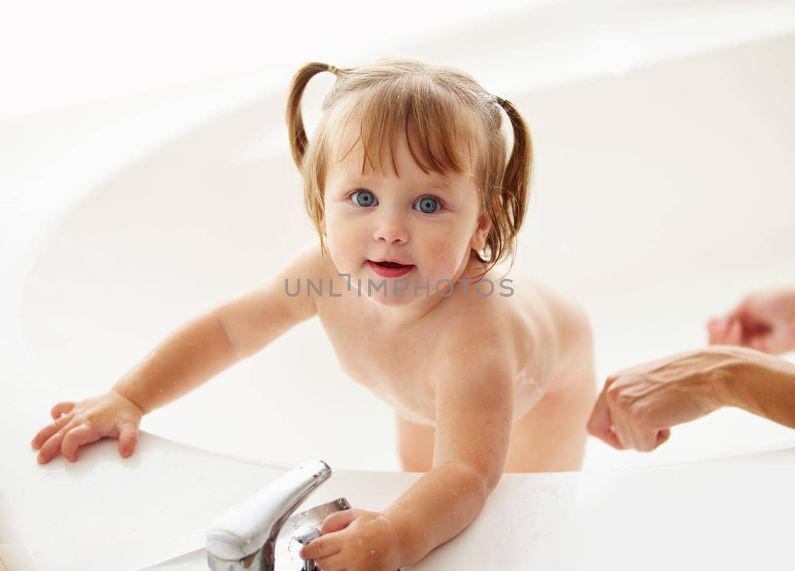 Portrait, cleaning and water with a baby in the bath for childhood hygiene or natural skincare. Children, bathroom and a happy young toddler girl in a bathtub for health and wellness in her home by YuriArcurs