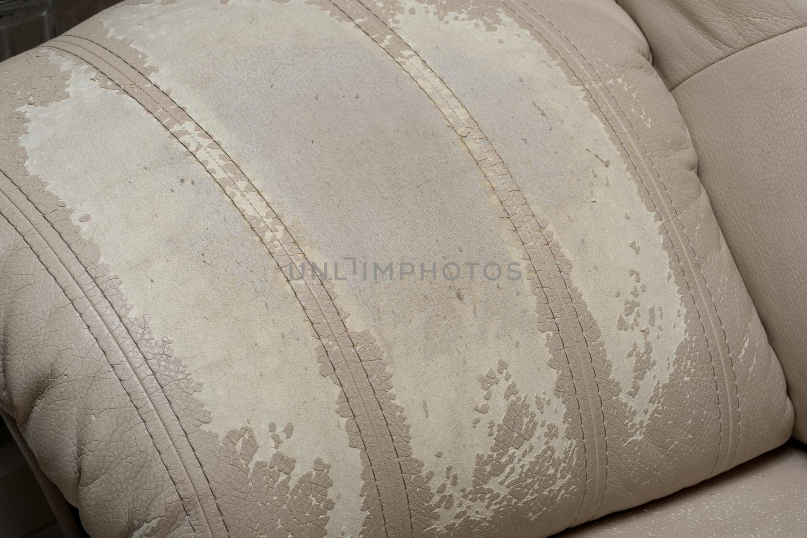 Defects on a white leather sofa. Damaged to leather furniture. by AnatoliiFoto