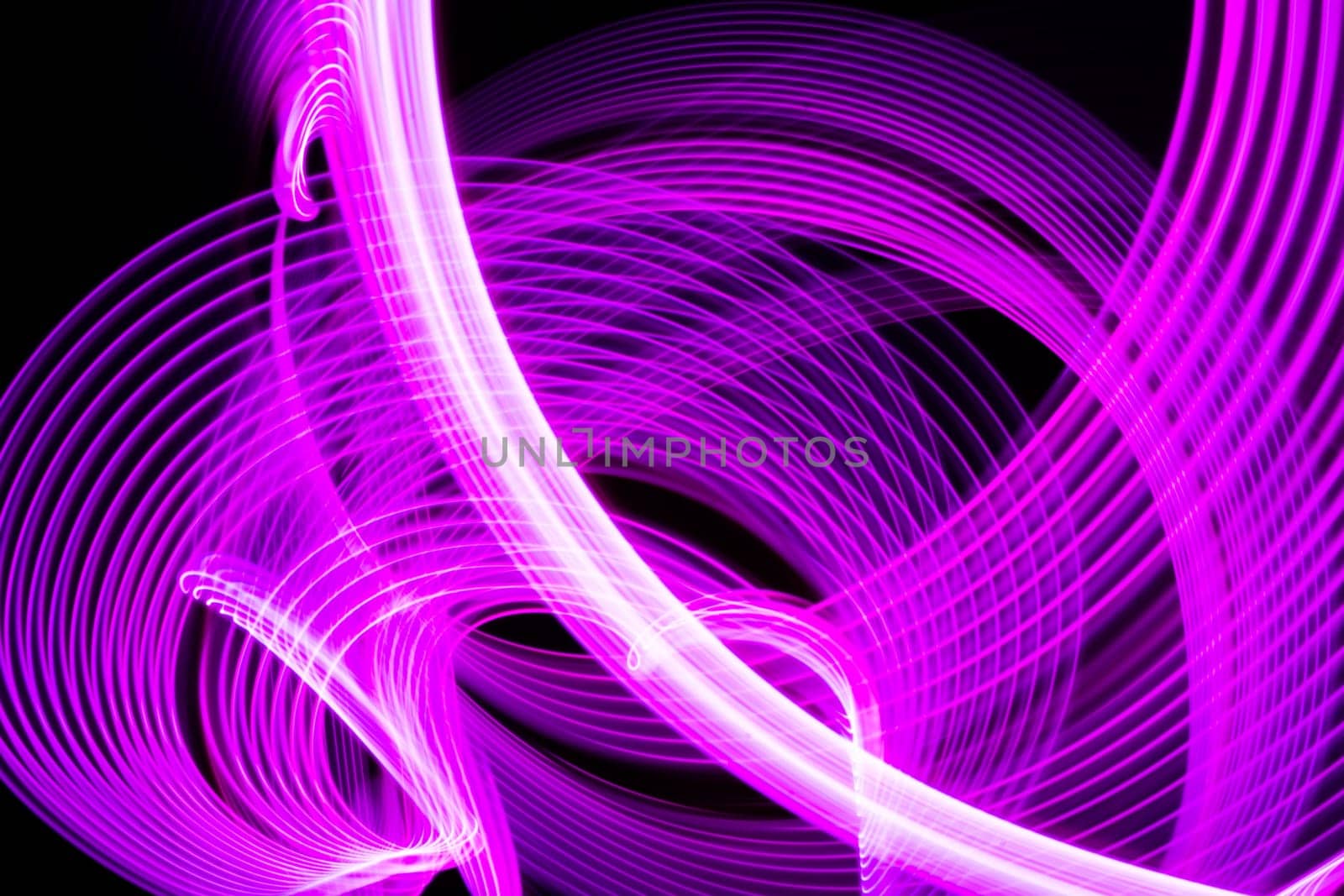 Abstract neon metallic pink curvy lines on black background. Technology data. High quality photo