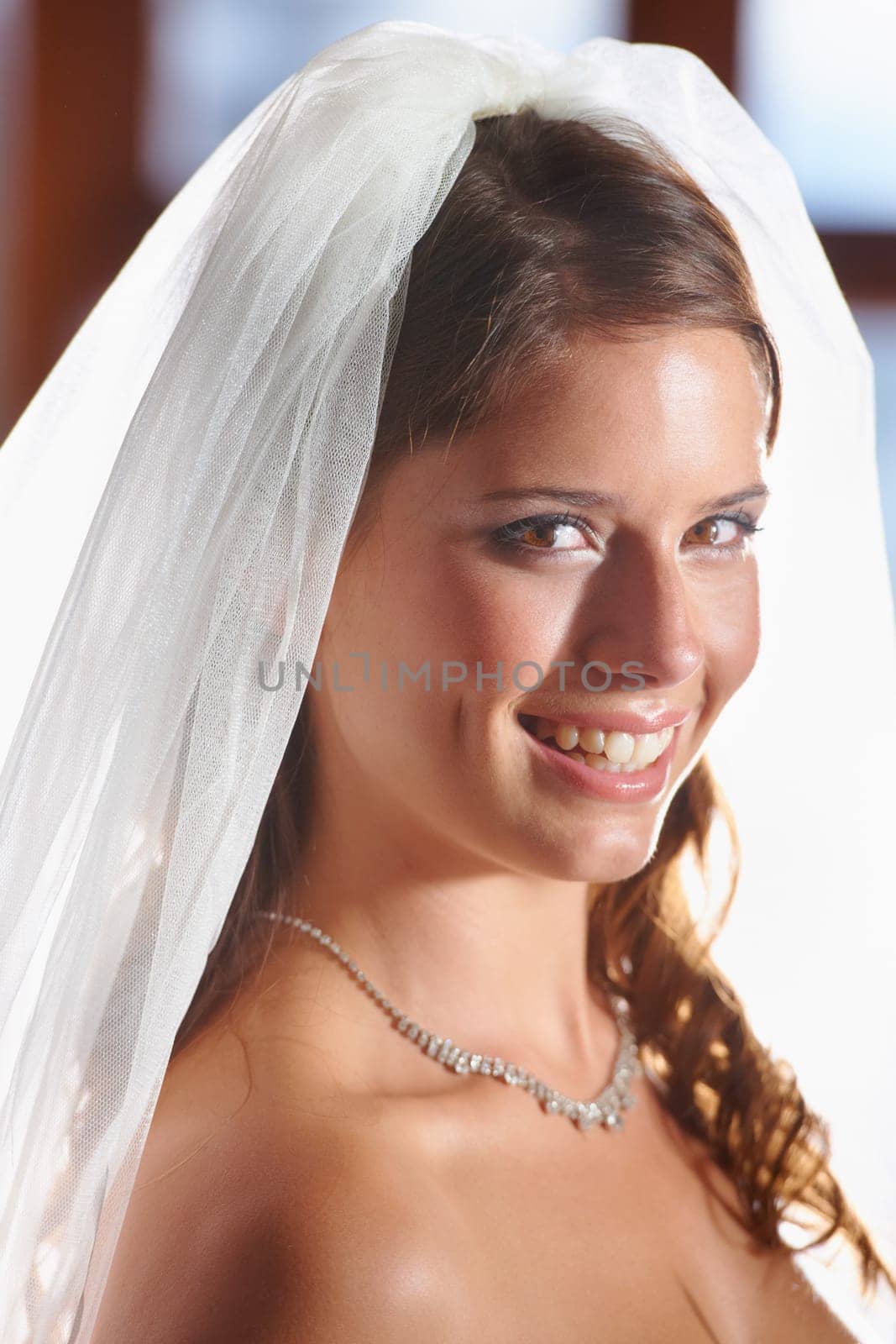 Bride, portrait and smile for love, wedding commitment and celebration ceremony with a veil. Jewelry, woman and happy from future marriage, romance and formal event in a church with a bridal dress by YuriArcurs