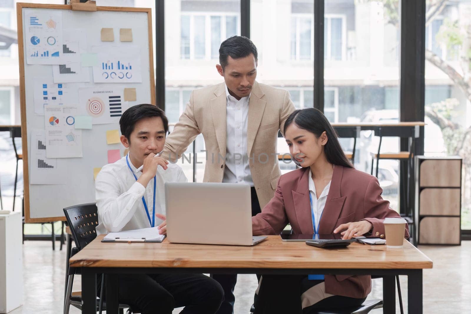 Group of business people working together and solving the problem of working stress in the meeting room at the office. by wichayada