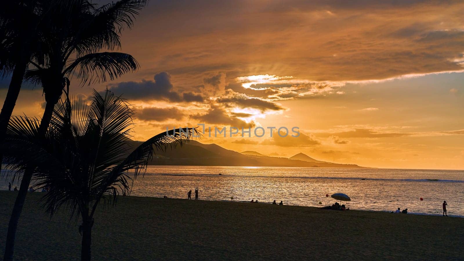 Sunset view at Playa de Las Canteras beach at Las Palmas de Gran Canaria, Spain by berezko