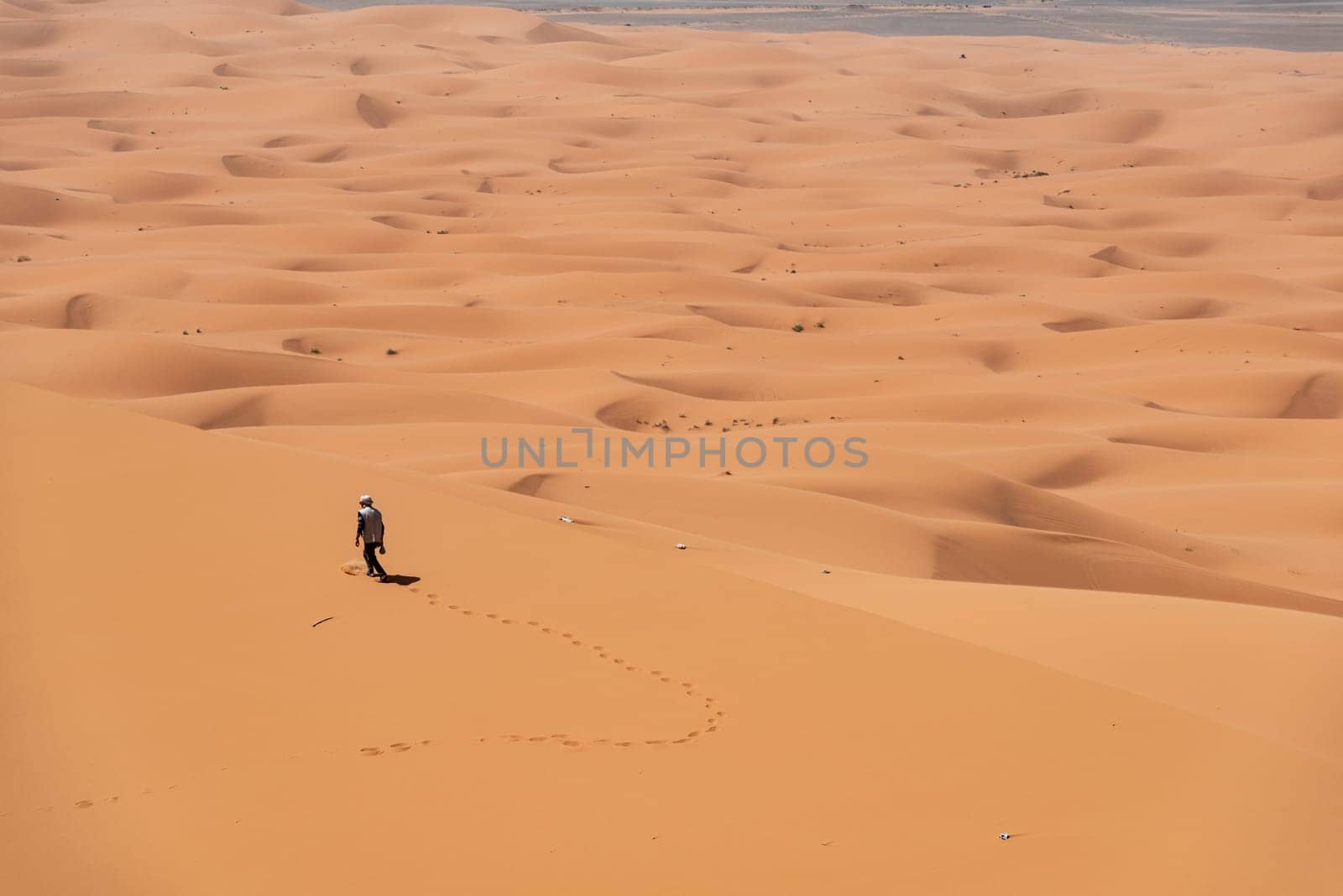 Hiking up the Great Dune of Merzouga in the Erg Chebbi desert, Moroccan Sahara desert