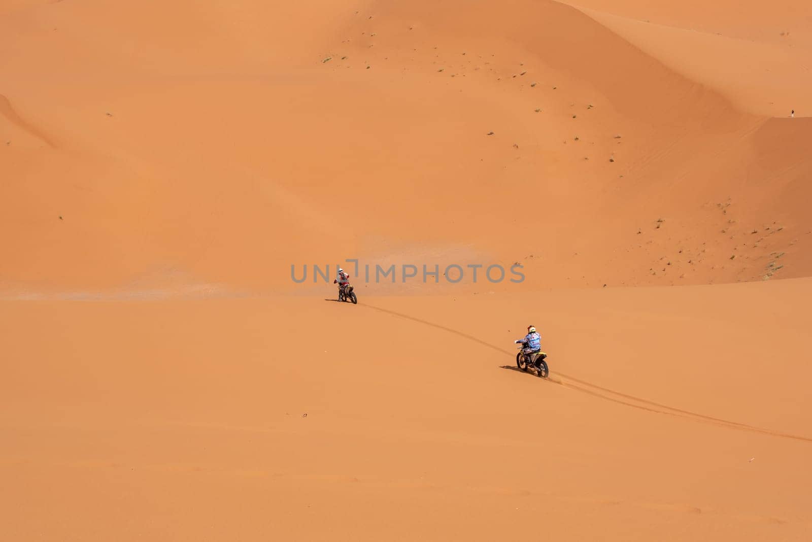 Motorbikers driving off-road in the Erg Chebbi desert near Merzouga, Morocco