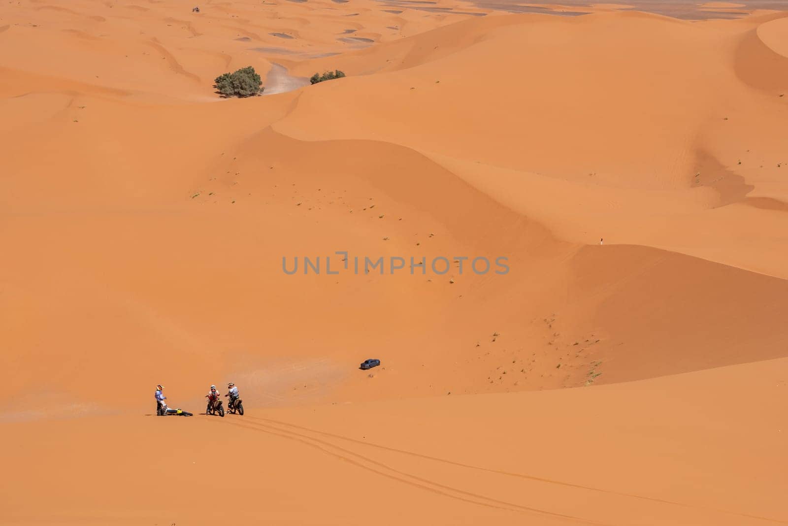 Motorbikers driving off-road in the Erg Chebbi desert near Merzouga, Morocco