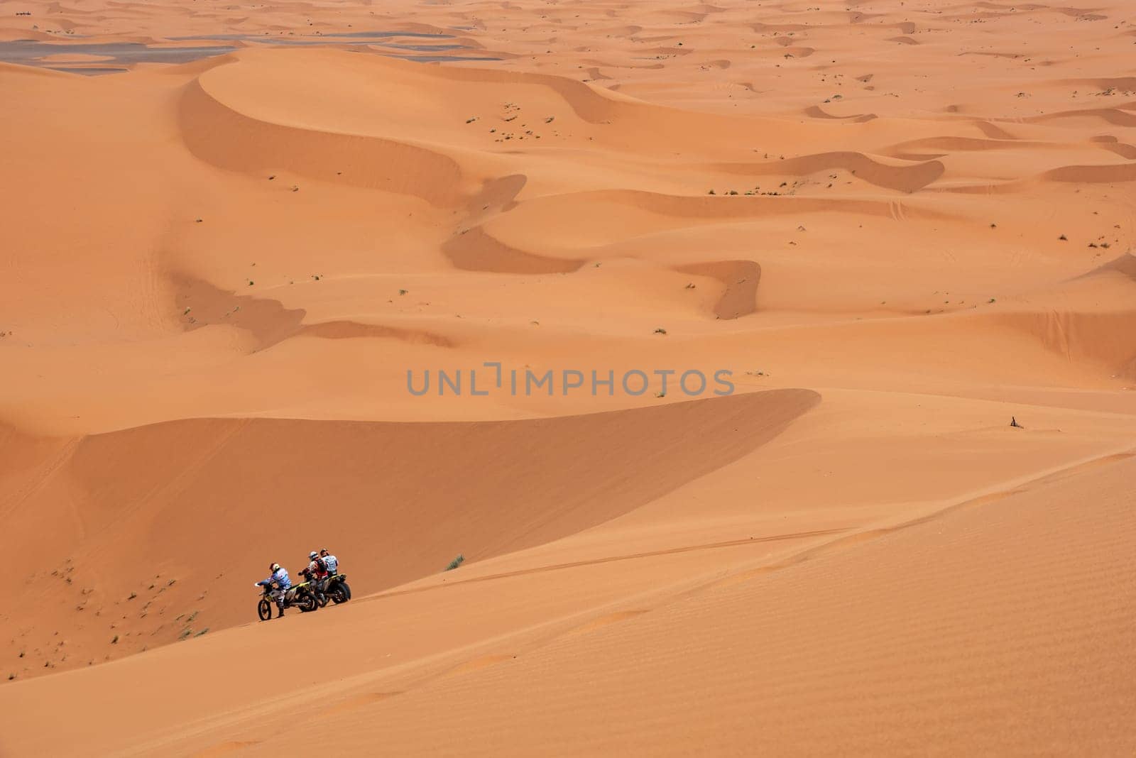 Motorbikers driving off-road in the Erg Chebbi desert near Merzouga, Morocco