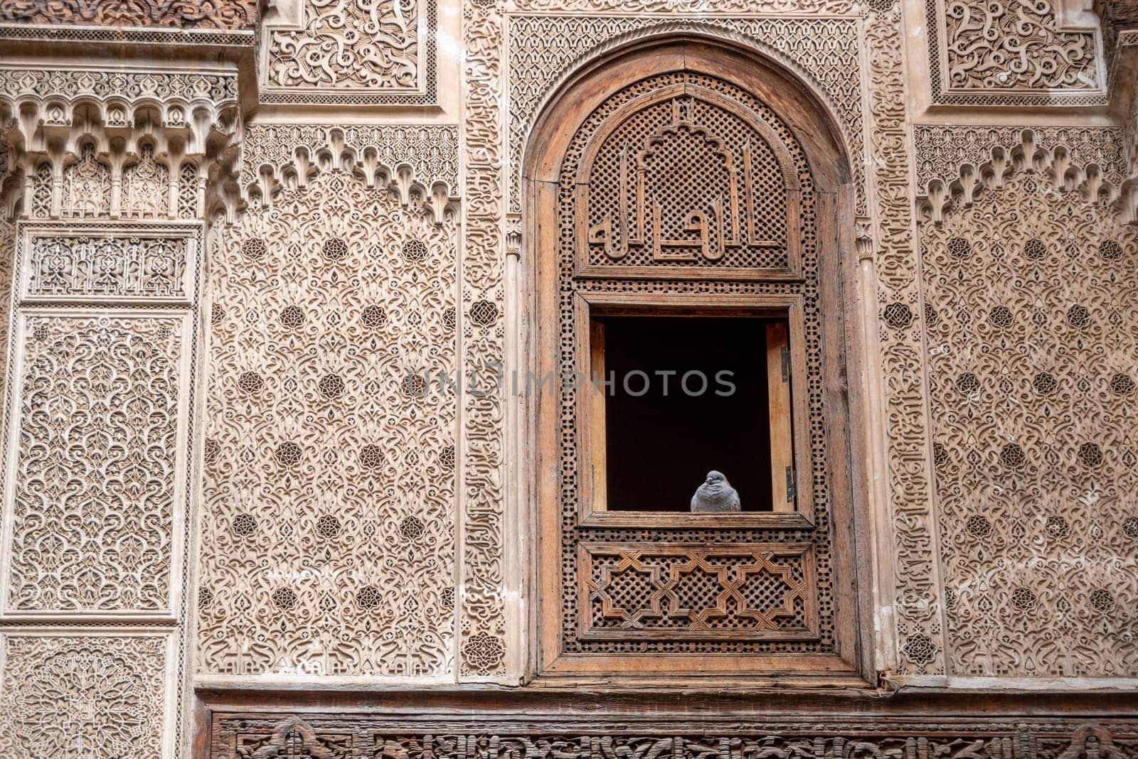 Rich decorated facade in the courtyard of the Medersa Attarine in Fes, Morocco