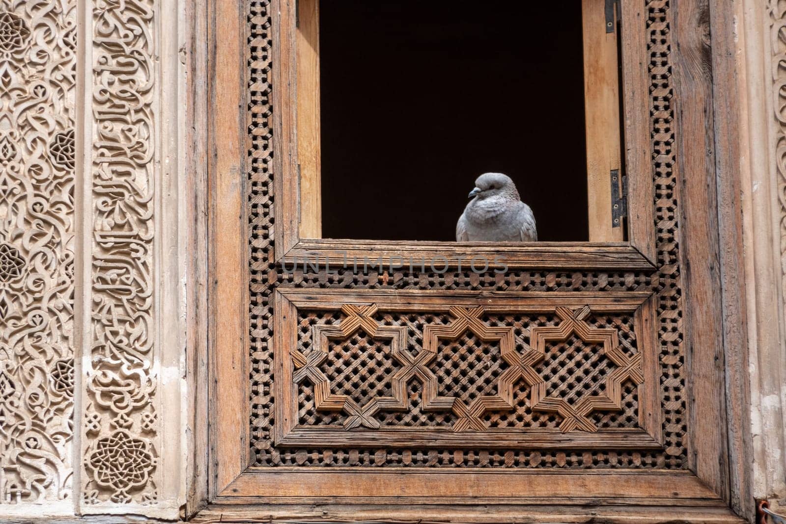 Rich decorated facade in the courtyard of the Medersa Attarine in Fes, Morocco