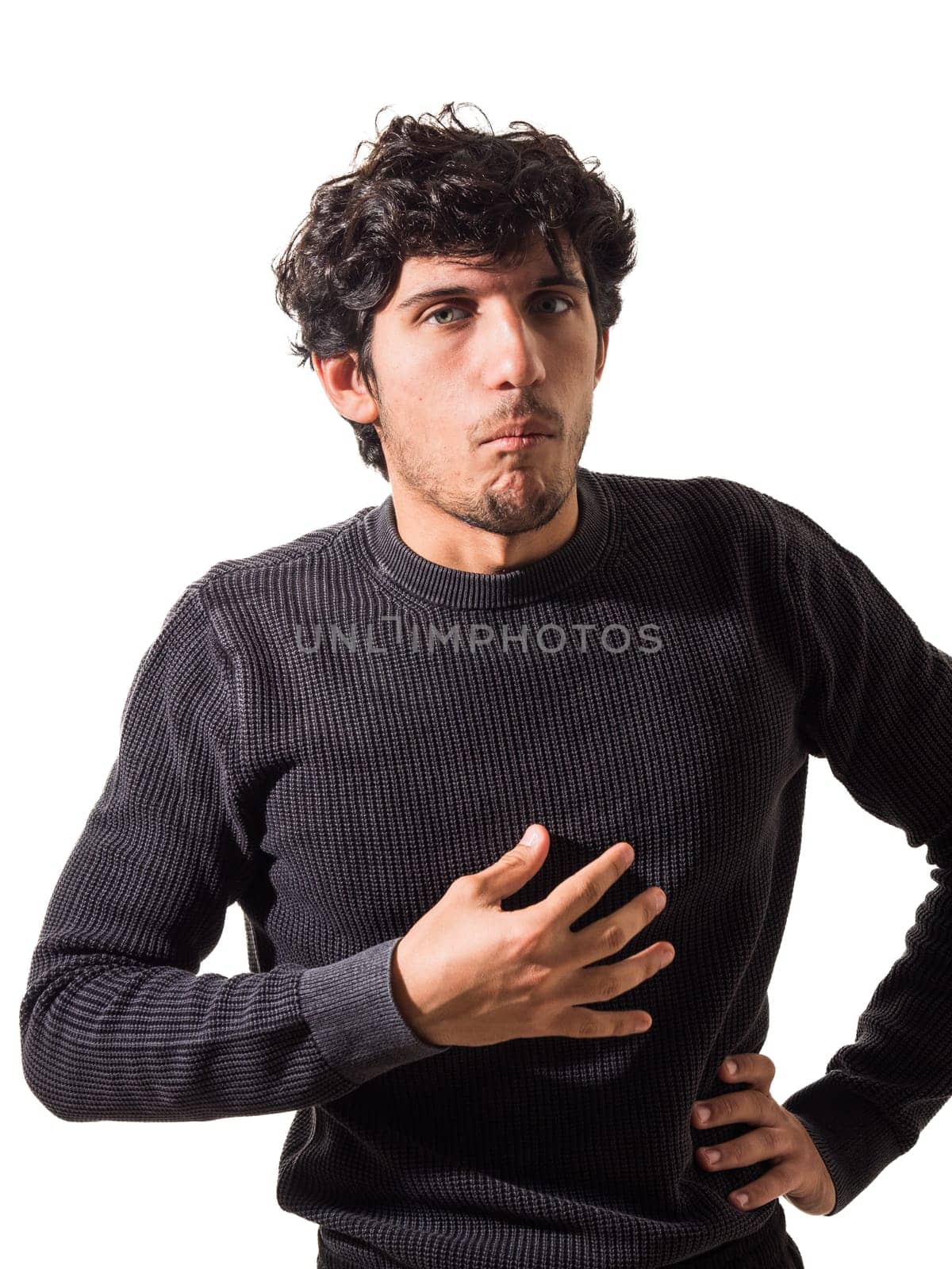 A young attractive man with his hands on his chest, suffering from heart pain, heartache, heartburn or chest pain, isolated on white