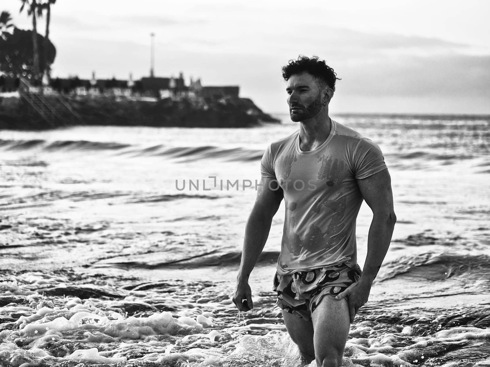 Handsome, hot young bodybuilder in the sea showing his muscular torso and arms - Muscular and fit young bodybuilder in the sea