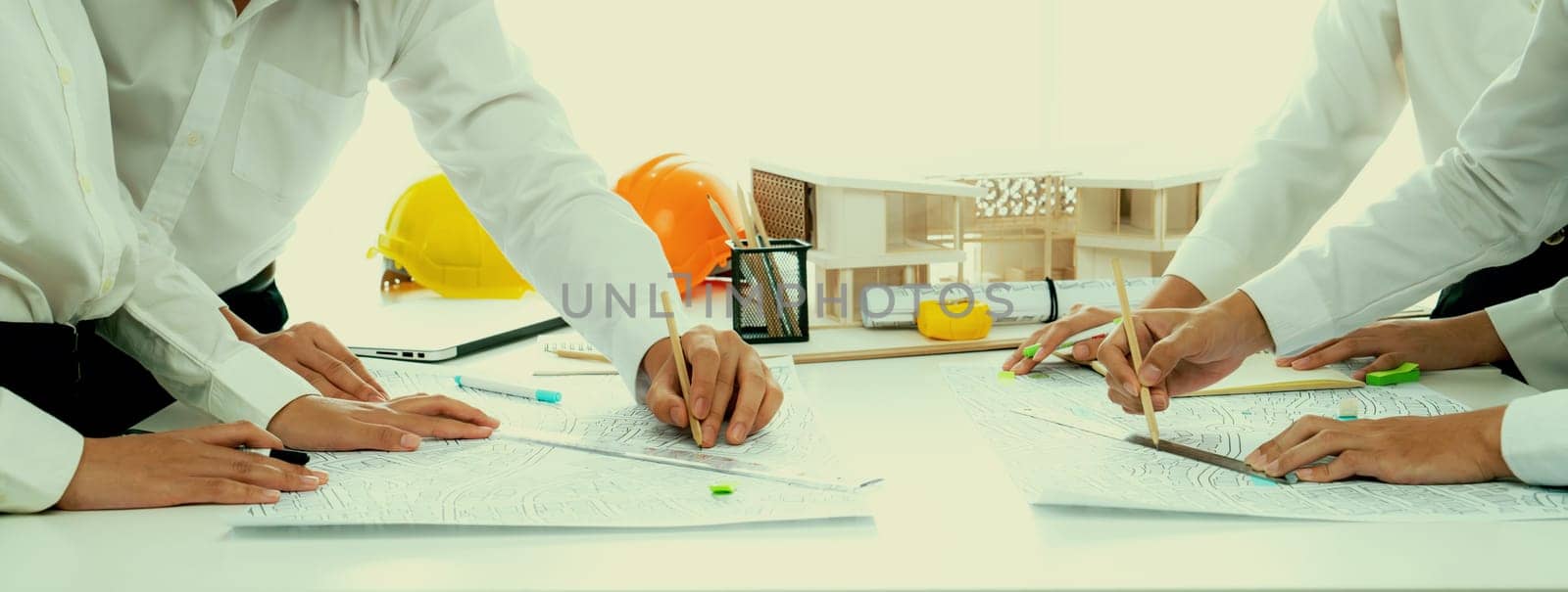 Worker, architect and engineer work on real estate construction project oratory planning with cartography and cadastral map of urban town area to guide to construction developer business plan of city