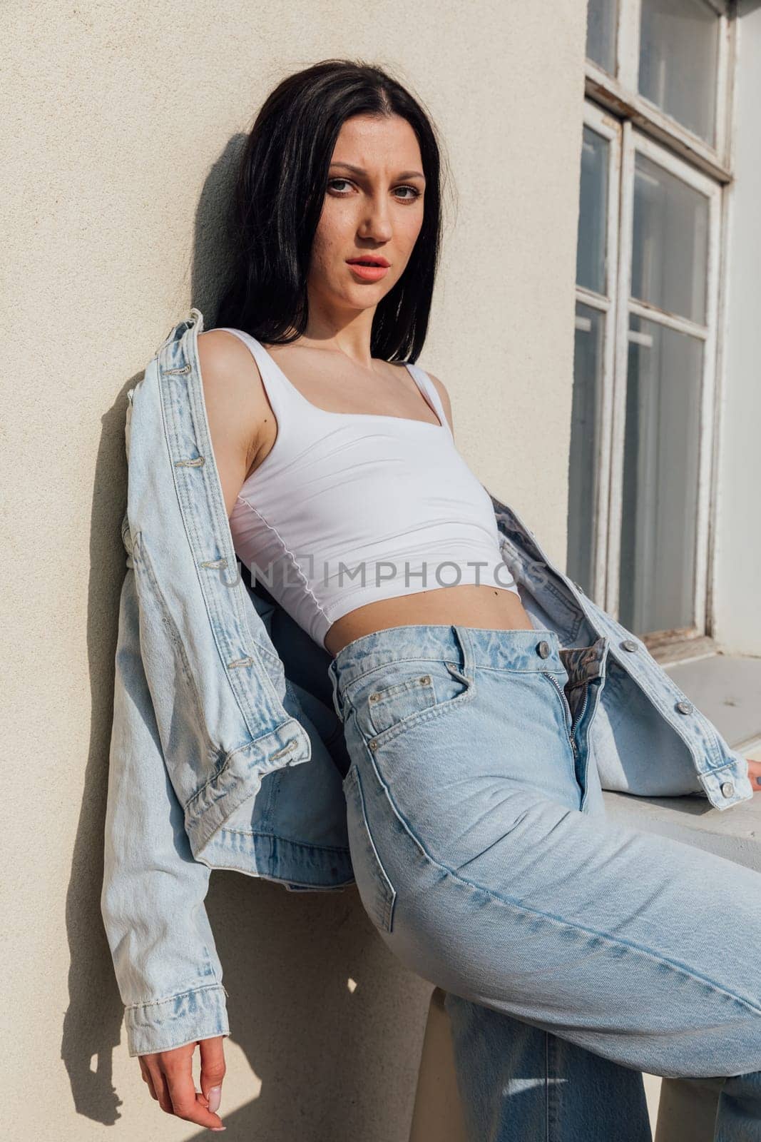 Portrait of a beautiful brunette woman in denim clothes by Simakov