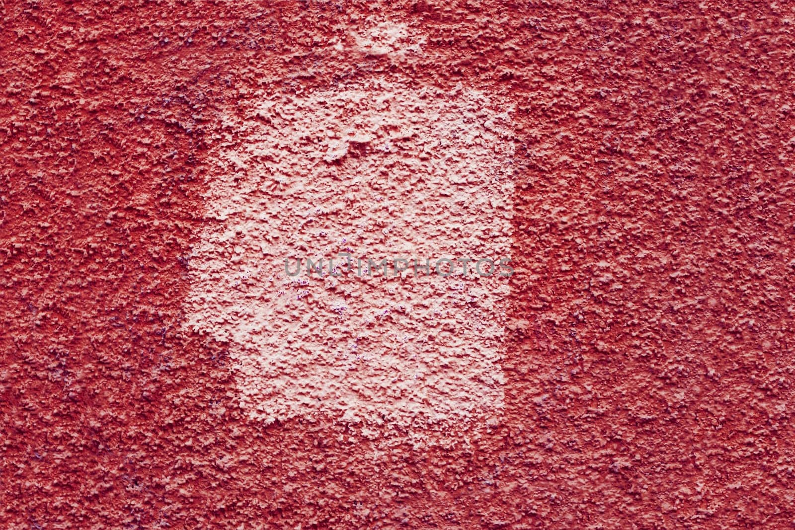 Red wall with a white square-shaped spot. Texture of old plaster with stain.