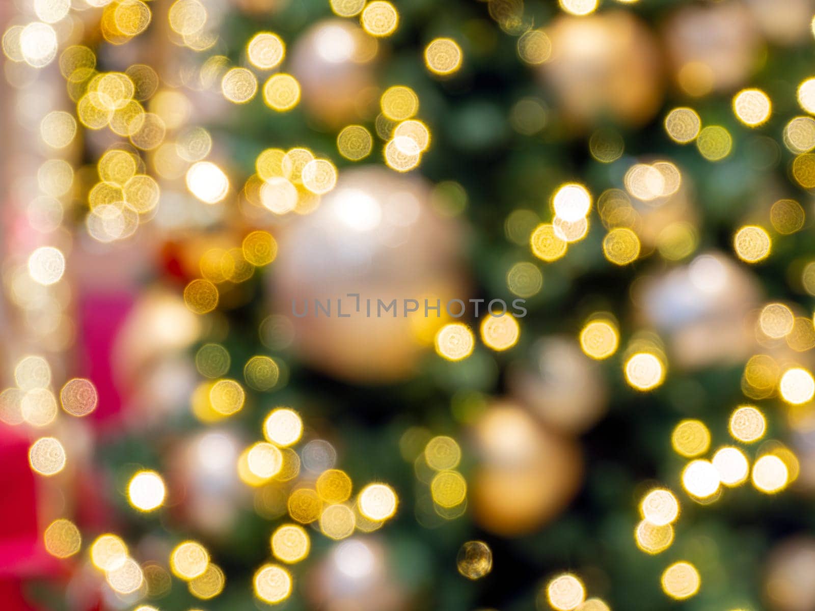 Yellow gold holiday lights on blur Christmas tree background. Abstract backdrop