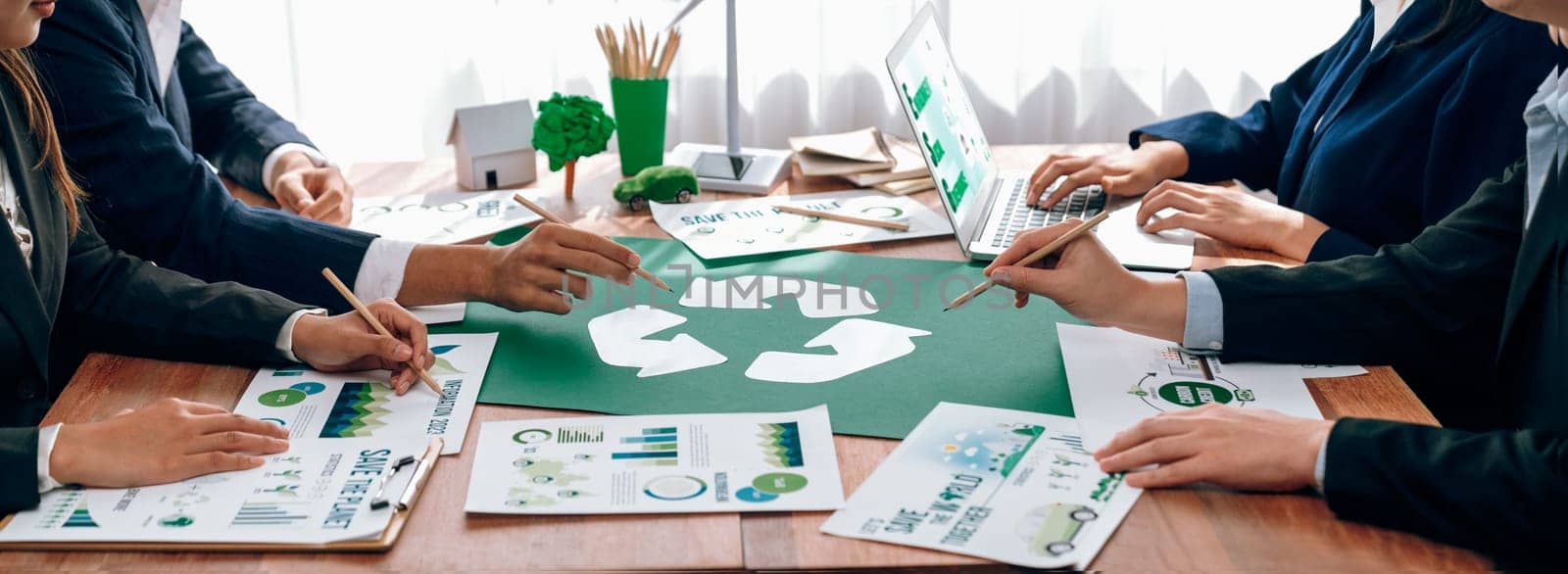 Group of business people planning and discussing on recycle reduce reuse policy symbol in office meeting room. Green business company with eco-friendly waste management regulation concept.Trailblazing