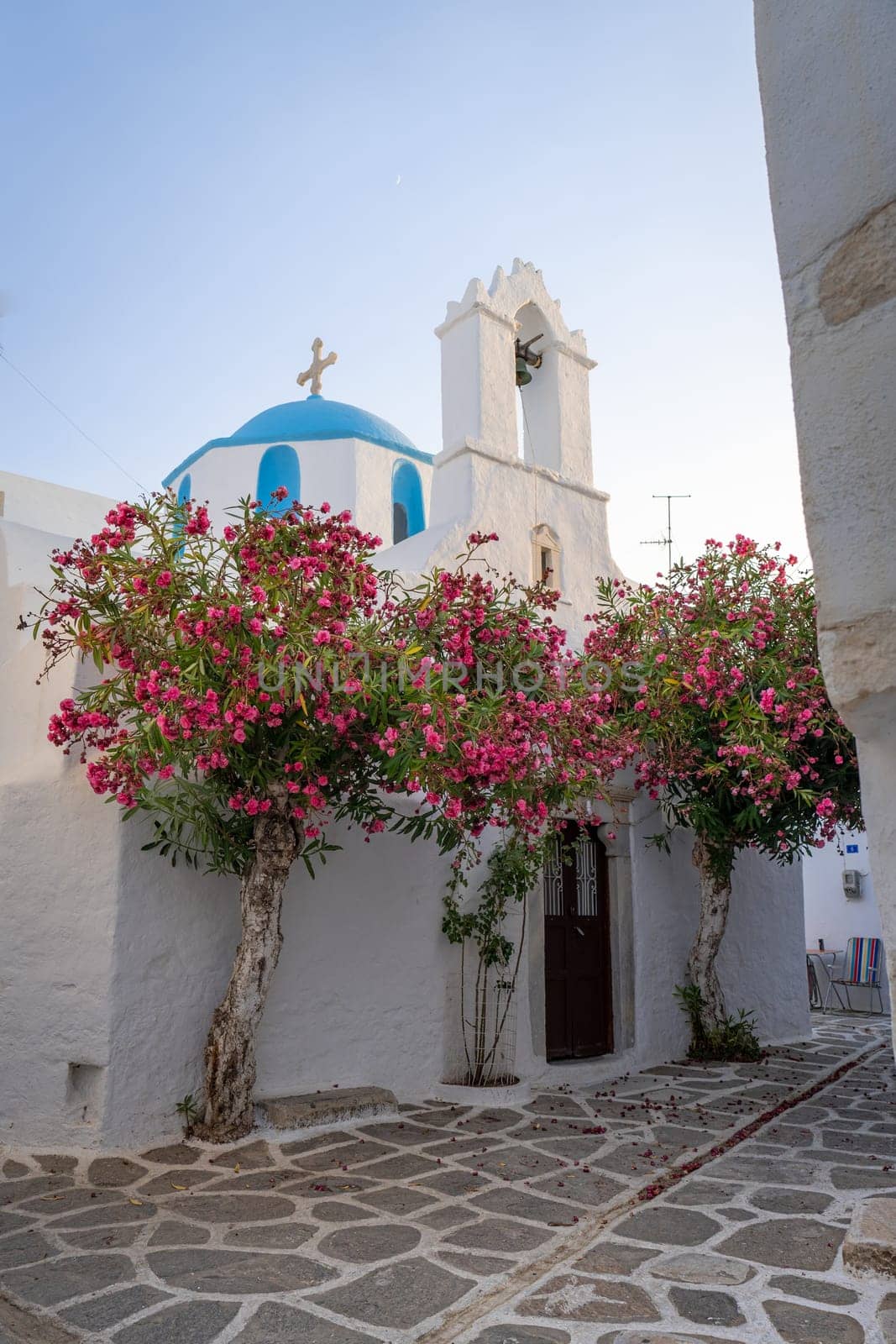 Small church in Parikia, Paros, with blue dome and bougainvillea by LopezPastor