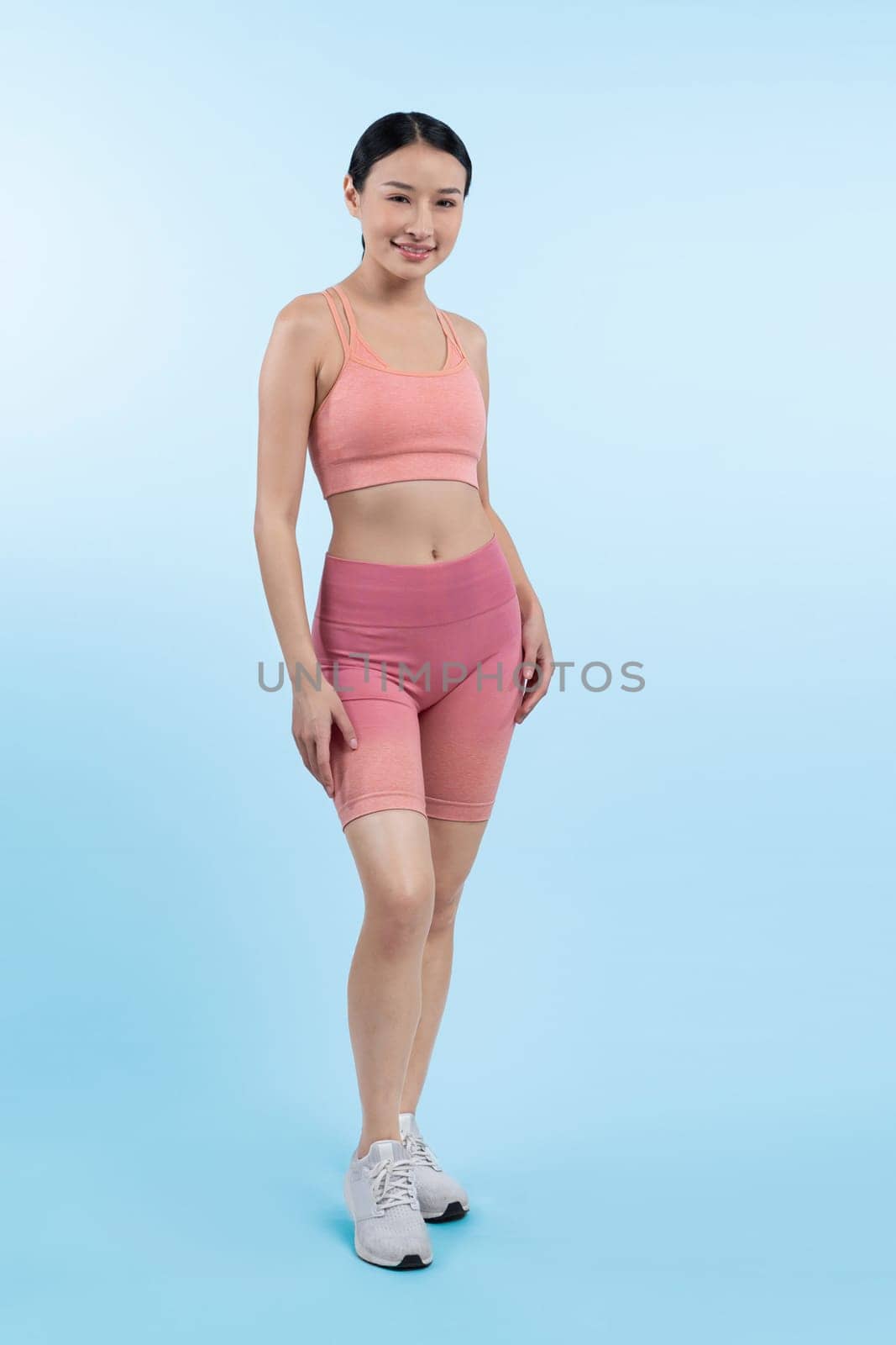 Full body asian woman in sportswear portrait, smiling and posing cheerful gesture. Workout training with attractive girl engage in her pursuit of healthy lifestyle. Isolated background Vigorous