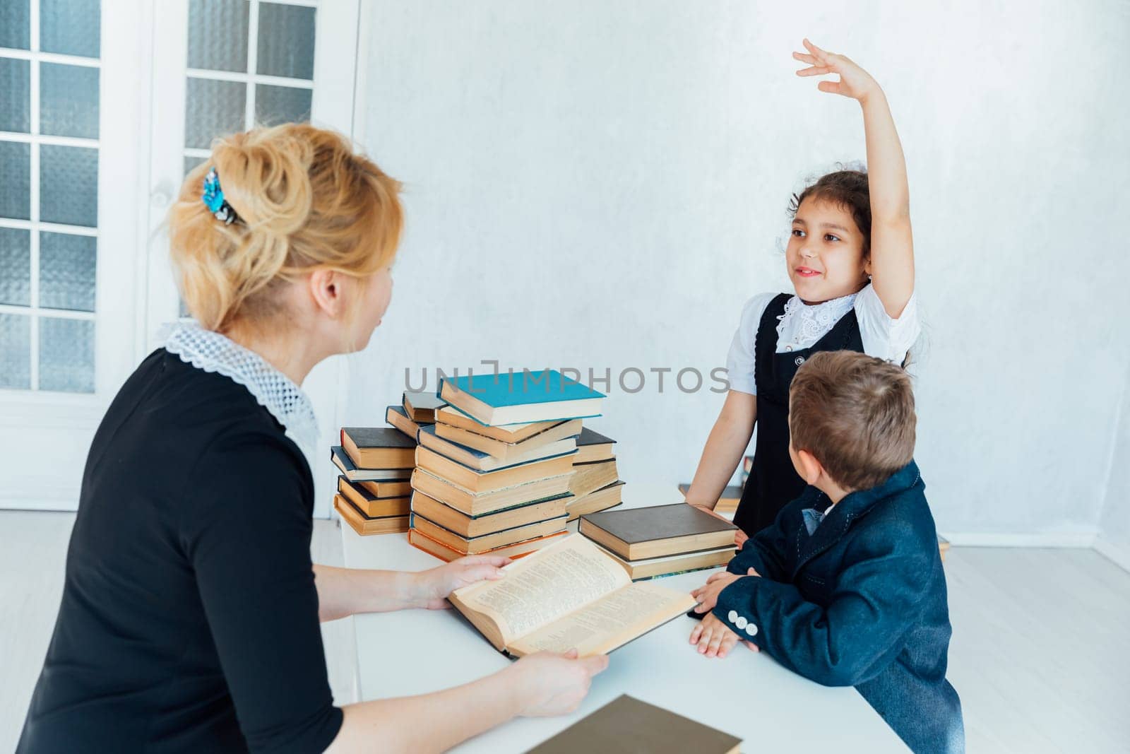 teacher teaching children in school classroom