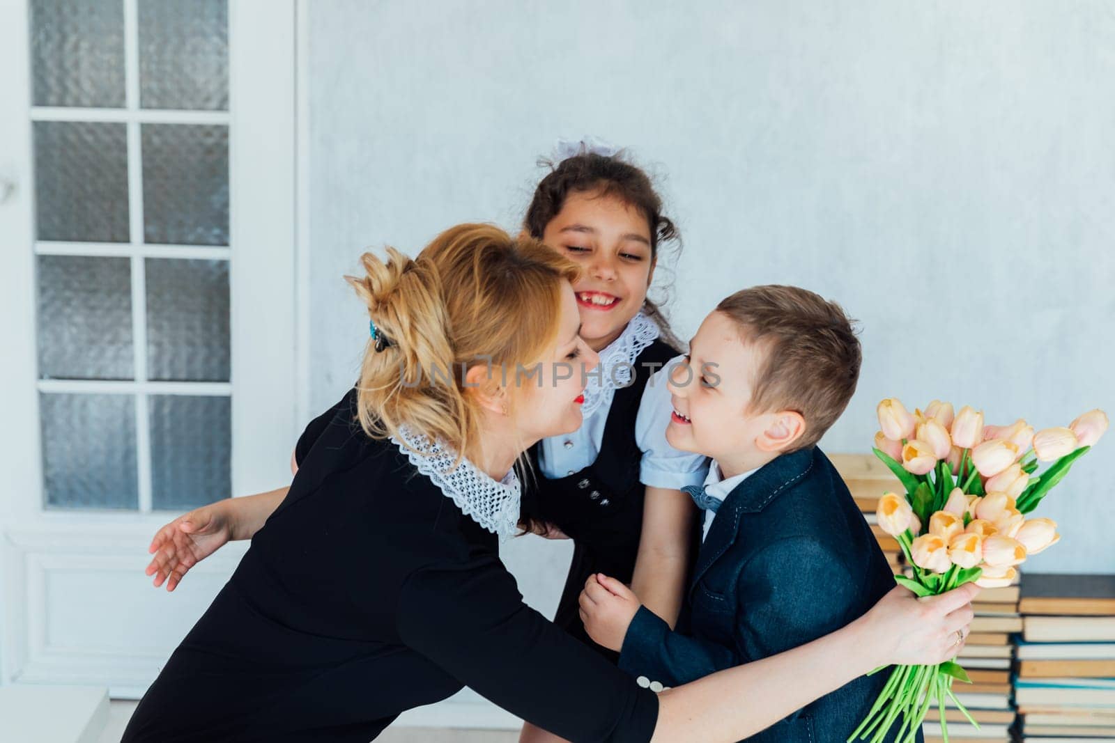 Children congratulating the teacher on the holiday