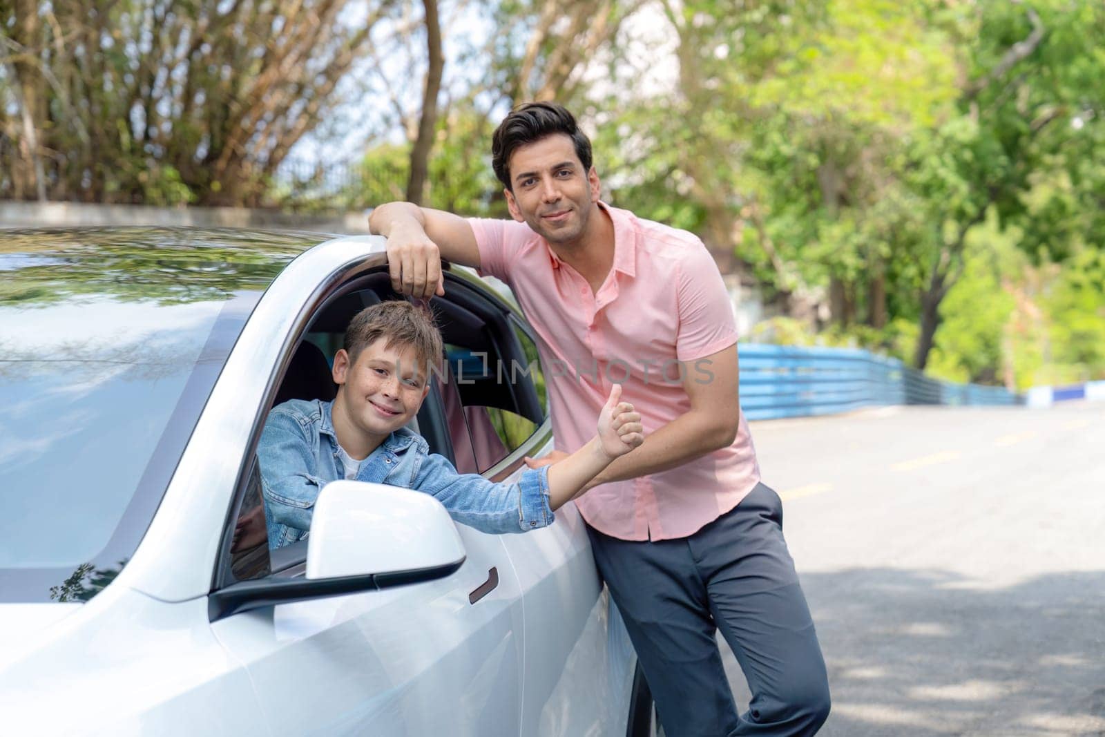 Dad and son on the road trip by the green nature countryside, family vholiday vacation concept. Young little boy enjoying family car adventure vacation with his father. Perpetual