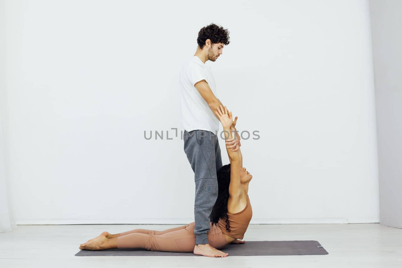 healthy back asana exercises woman and man practice yoga lotus pose stretching by Simakov