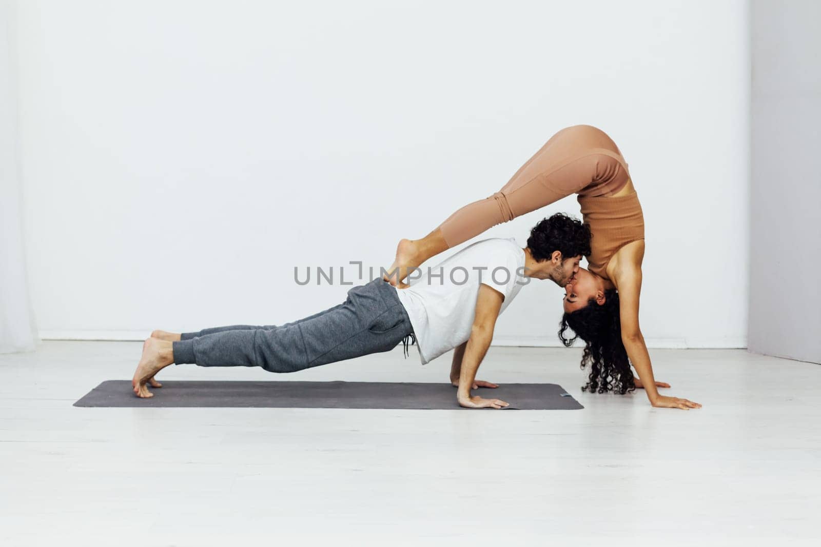 woman and man practice yoga lotus pose stretching healthy back asana exercises by Simakov