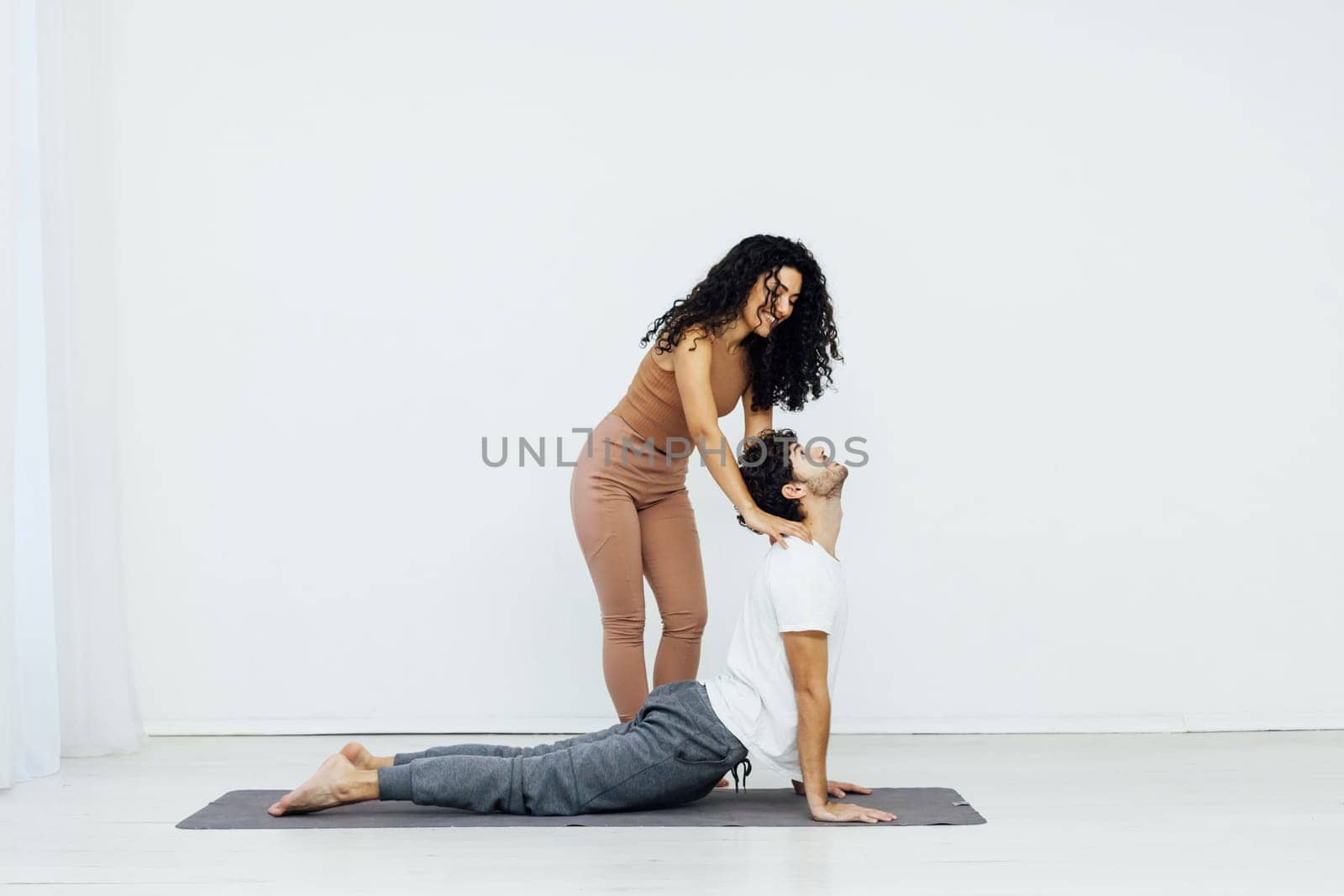 a woman and man practice yoga lotus pose stretching healthy back asana exercises