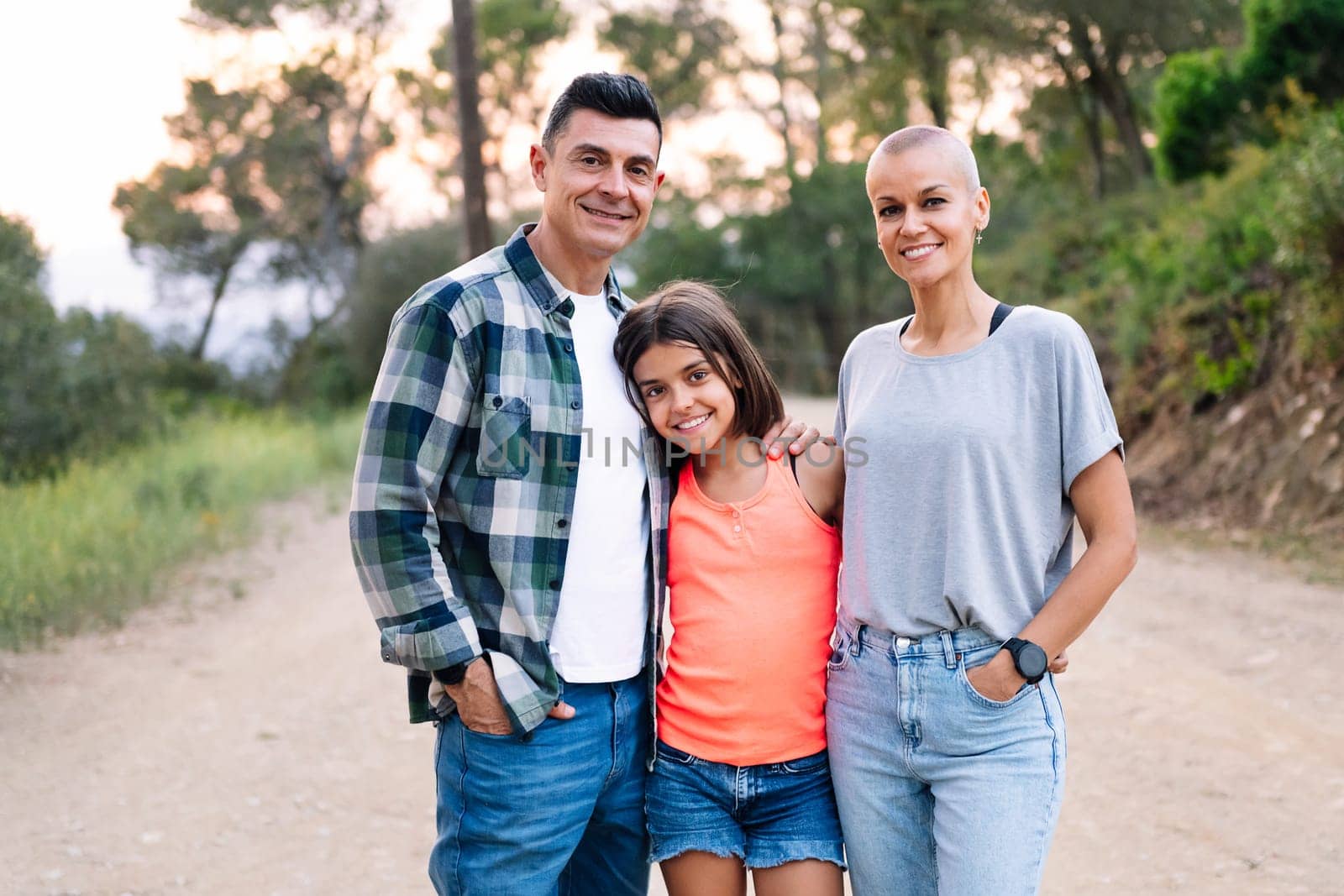 happy family smiling in the countryside by raulmelldo