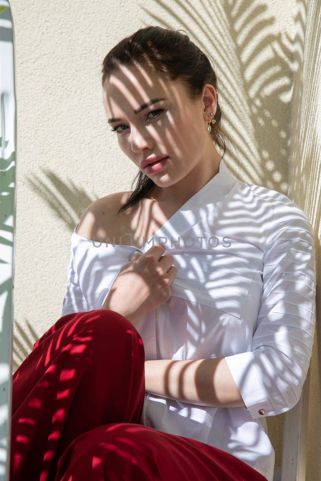 woman in the shade of palm leaves