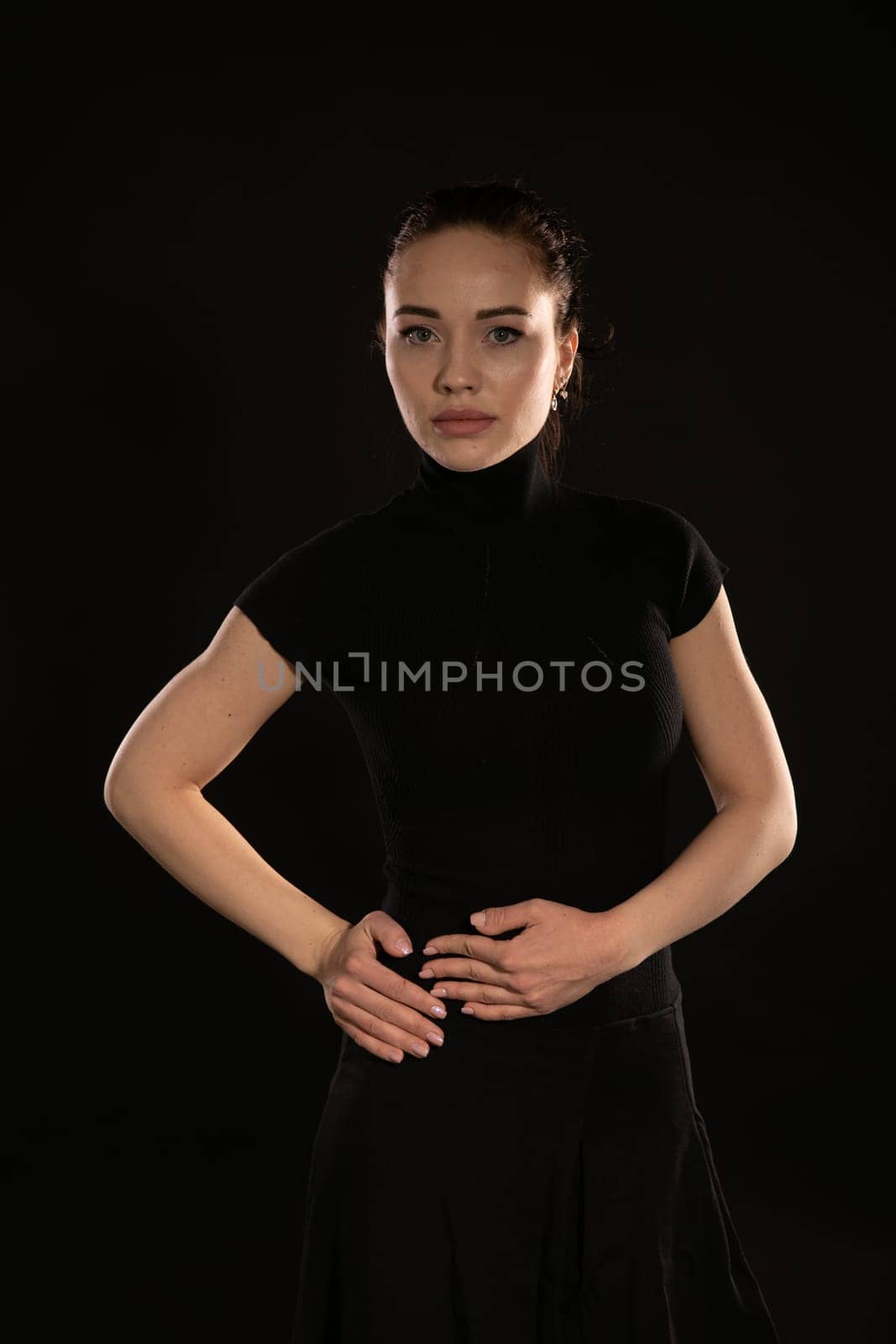 beautiful brunette woman in black dress dark by Simakov