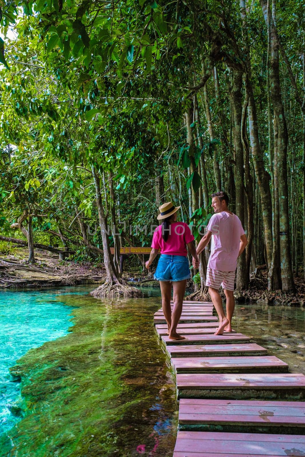 Emerald Lake and Blue Pool Krabi Thailand mangrove forest Krabi Thailand. Young Asian women and European men walking in the national park at the lake in Krabi Thailand