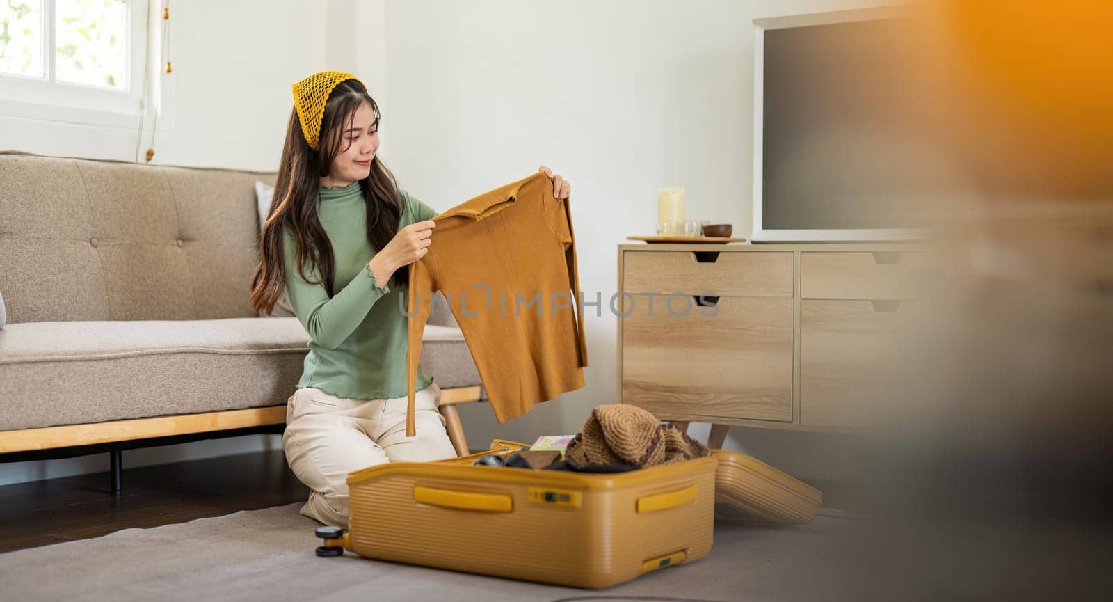 Beauty asian traveler woman packing prepare stuff and outfit clothes in suitcase travel bag luggage for holidays at home, weekend, tourist, journey.