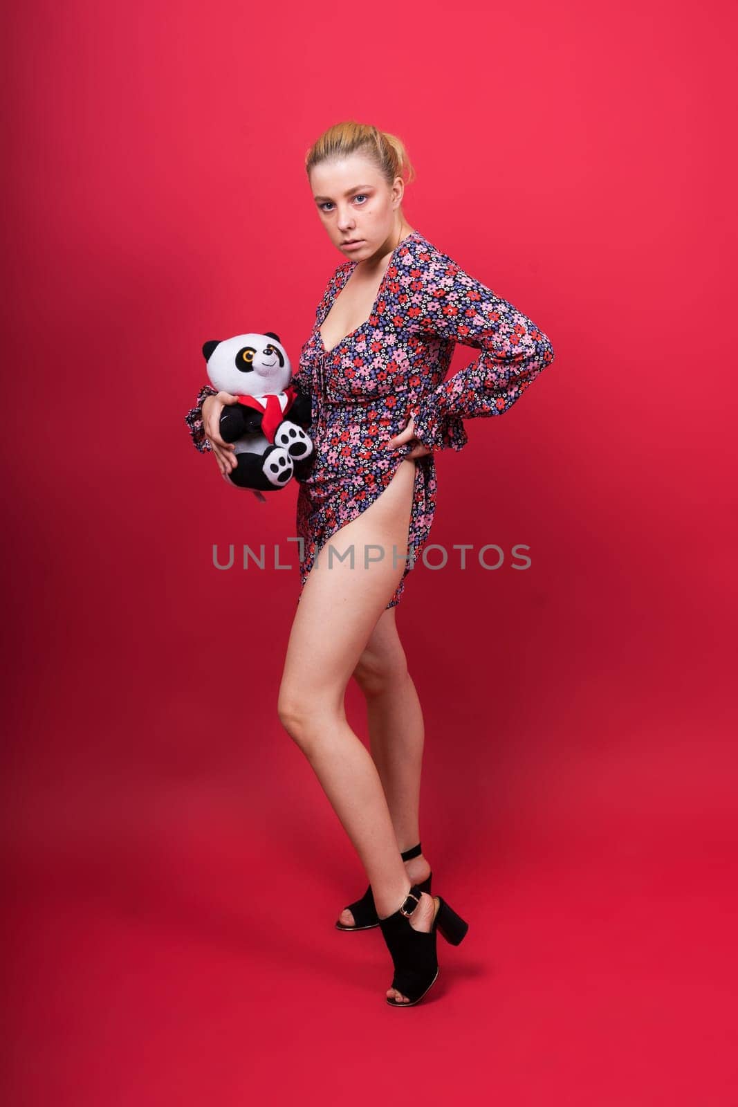 Portrait of seductive woman posing in studio with panda by Zelenin