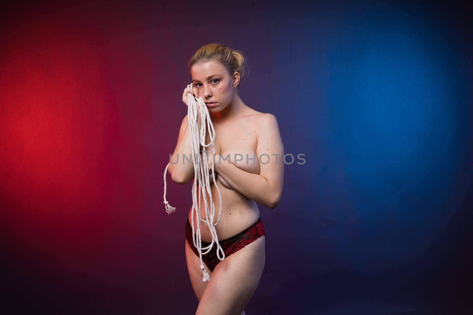 Low key portrait of beautiful female body on a dark background