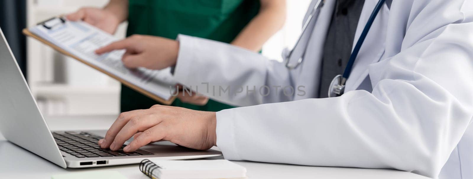 Professional various team of medical working and planning medical treatment at hospital table together. Teamwork lead to successful illness and sickness treatment. Panorama Rigid