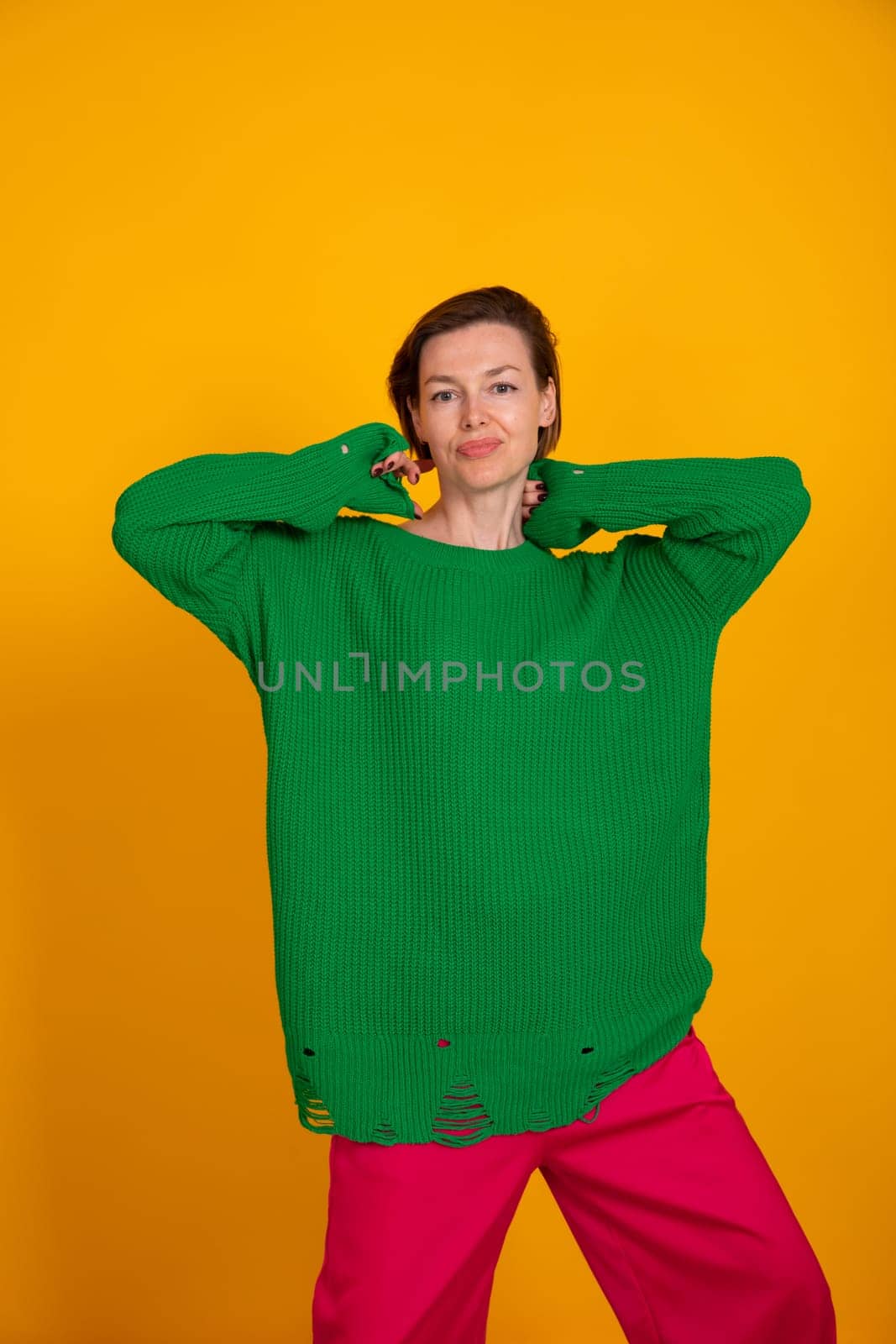 Beautiful slender woman in green knitted autumn sweater by Simakov