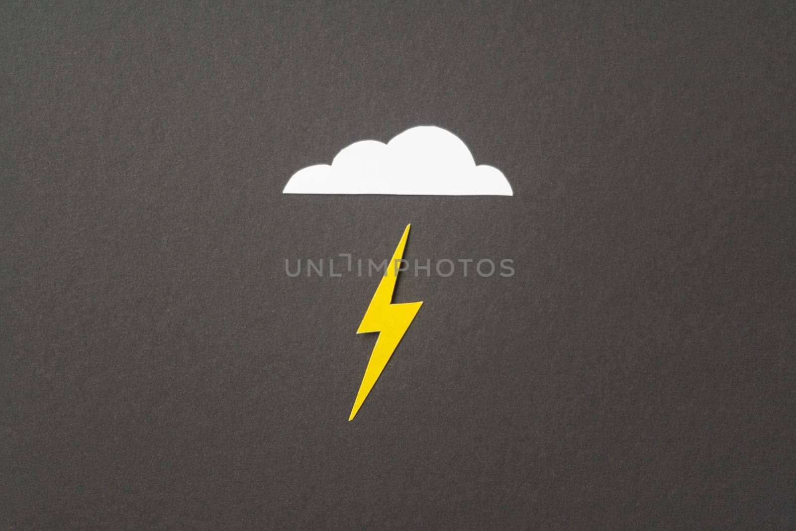 White cut out paper cloud and yellow lightning on black by Quils