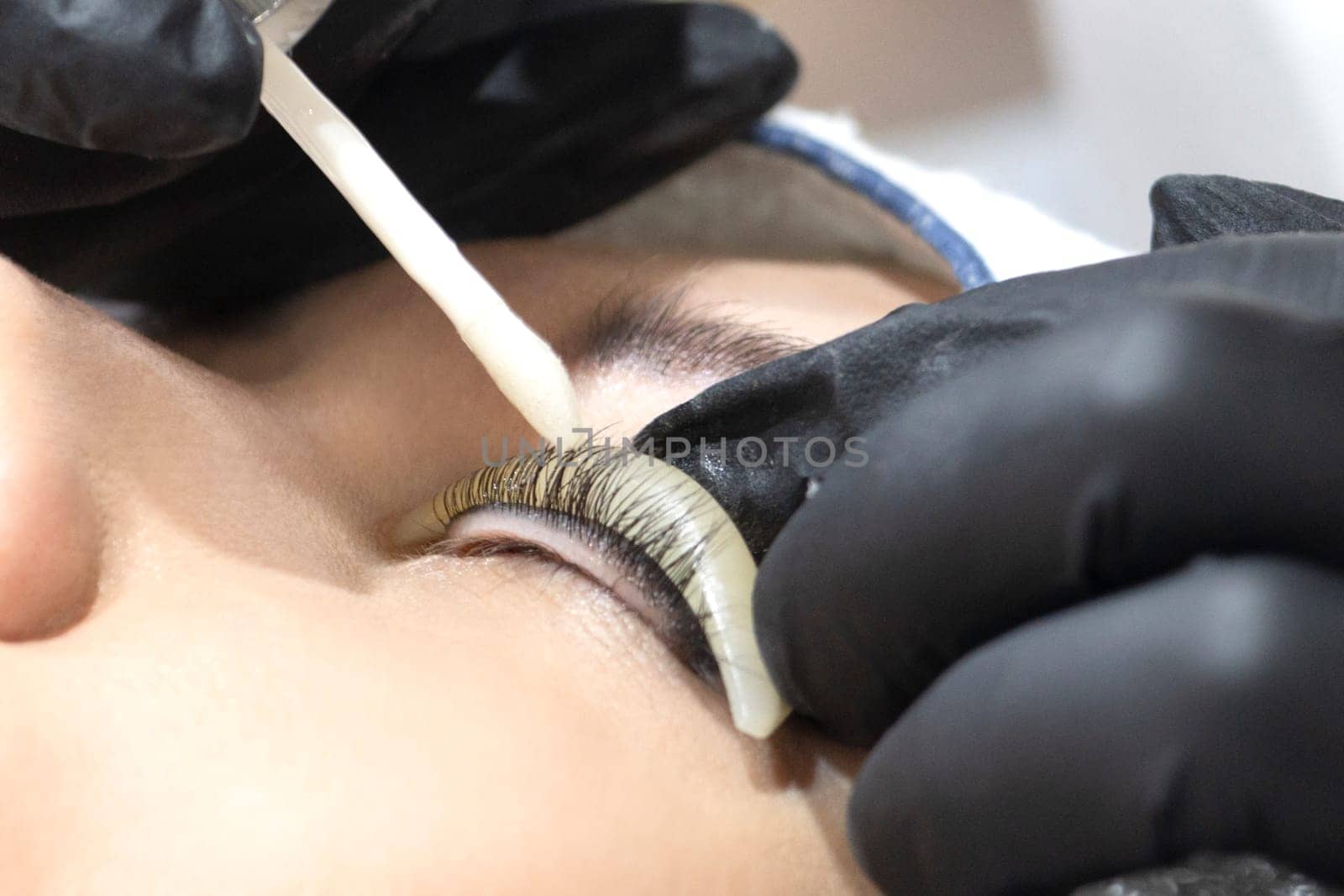 eyelash extensions, close-up, eye and hands of the master, beauty saloon