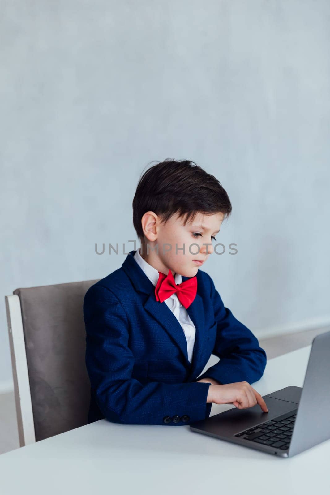 Boy in the classroom at the laptop online education communication