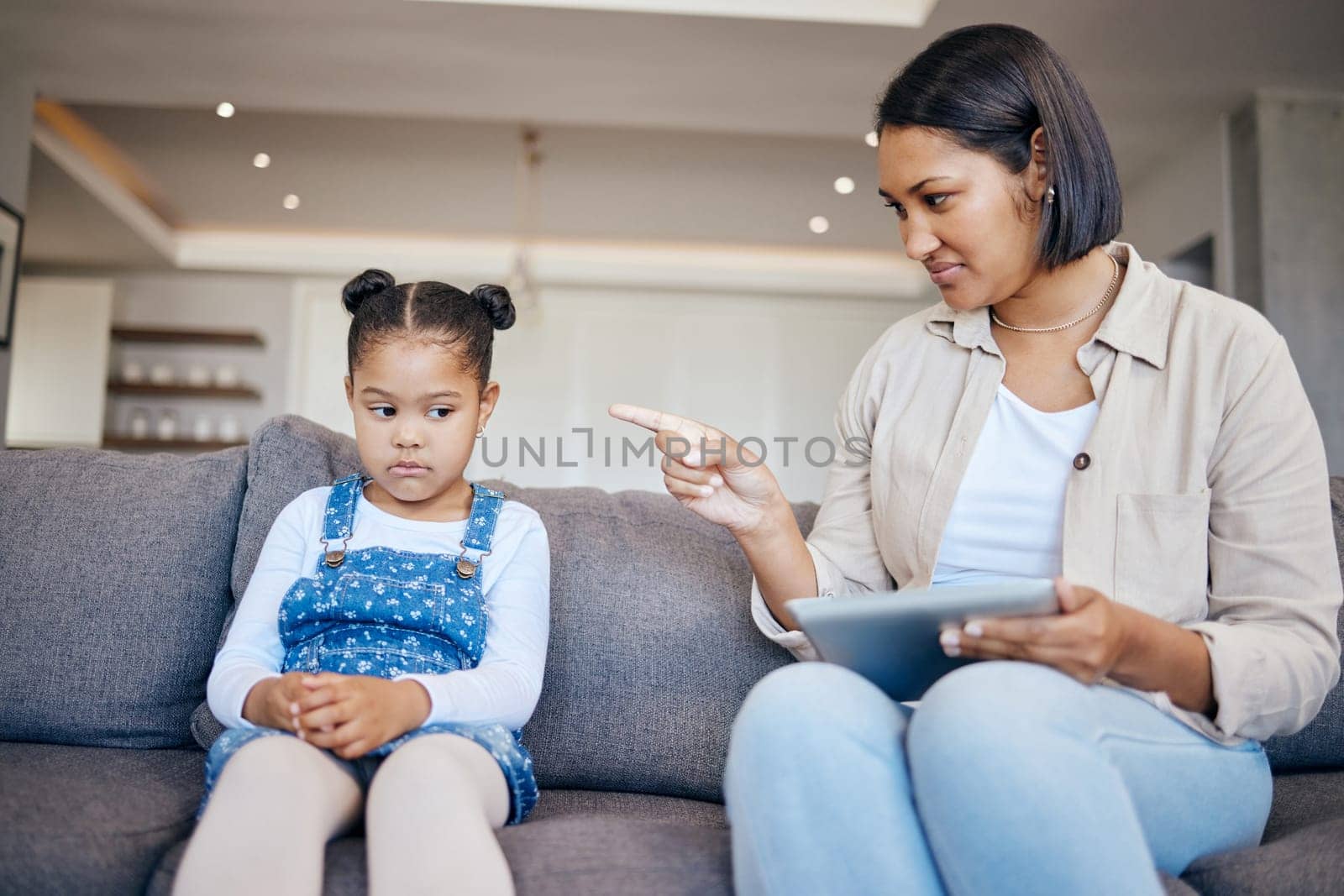 Mom, child and scolding or discipline, tablet and punishment for technology. Parent and daughter, communication and disappointed for cyberbullying, bad behaviour and frustrated for digital mistake.