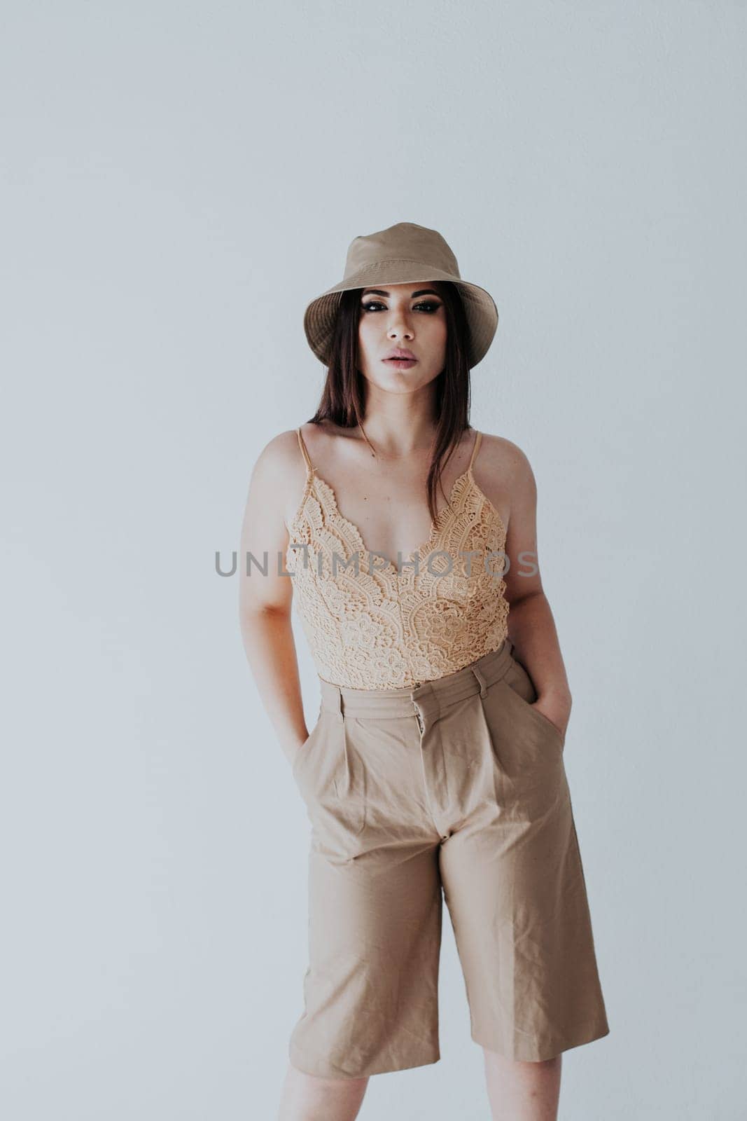 brunette in panama hat on white background