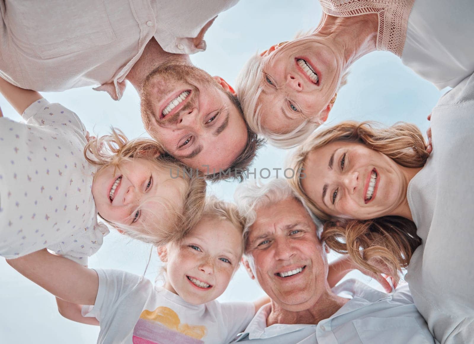 Happy family, portrait and huddle for bonding together, parents and kids with pov, blue sky and outdoor. Holiday, carefree and grandparents with smile, childhood memories and cheerful for vacation.