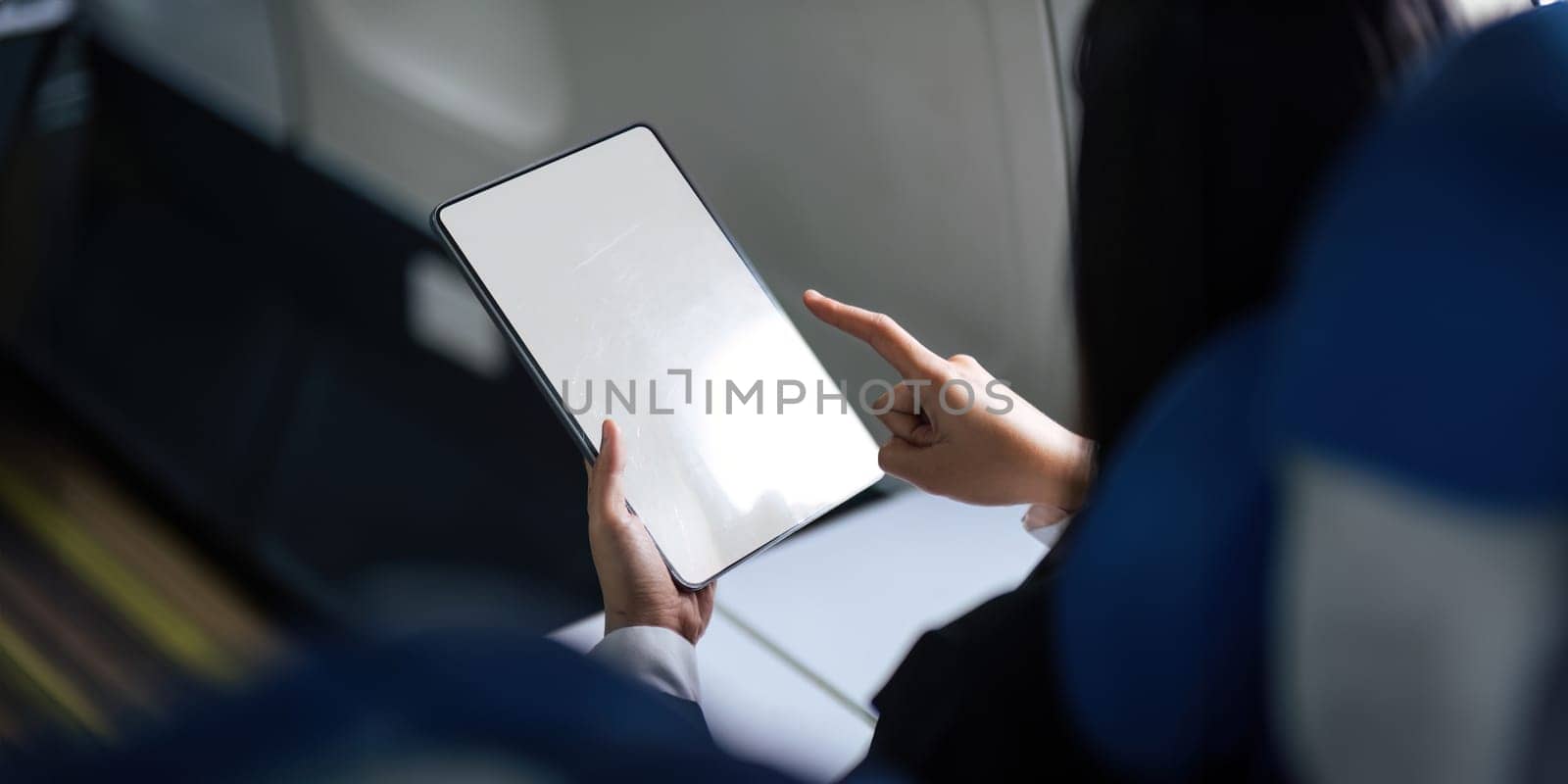 Business woman working on tablet computer. tablet vertical screen mockup.