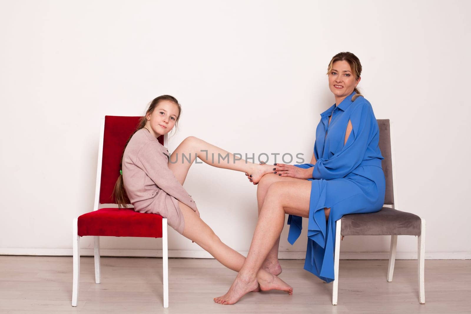 Mom and daughter posing near chairs Family Love by Simakov