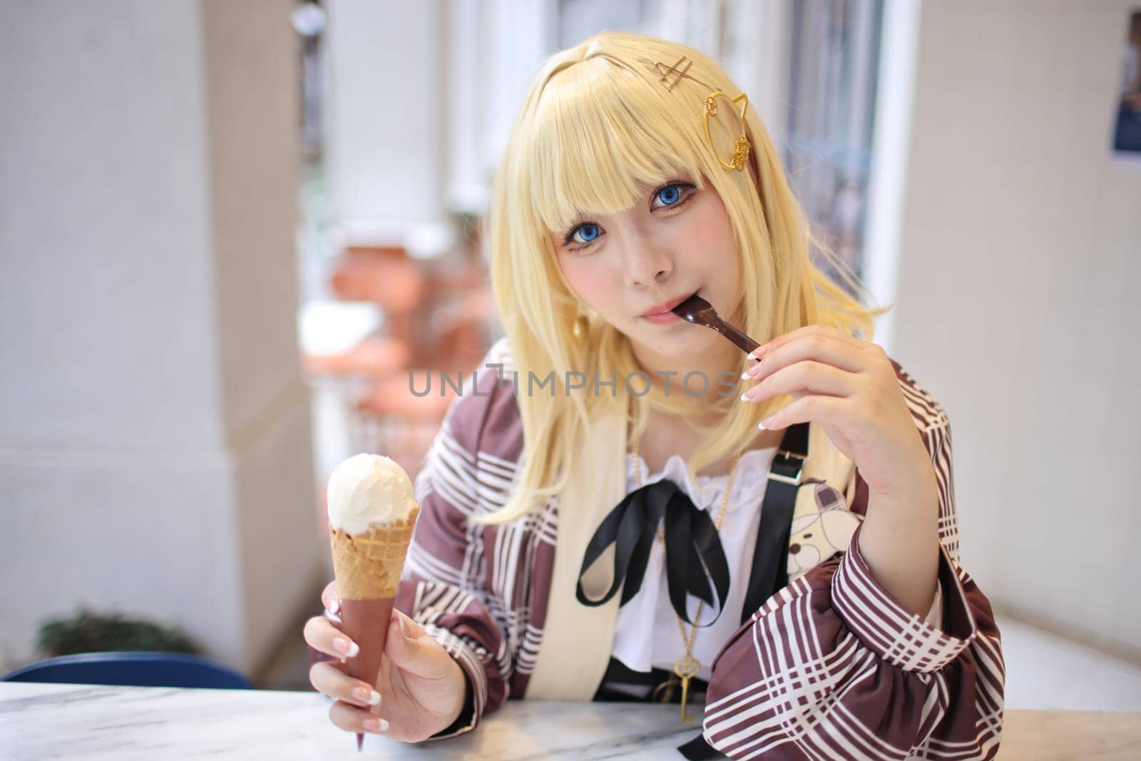 Portrait of a beautiful young woman game Cosplay with blonde hair with ice cream